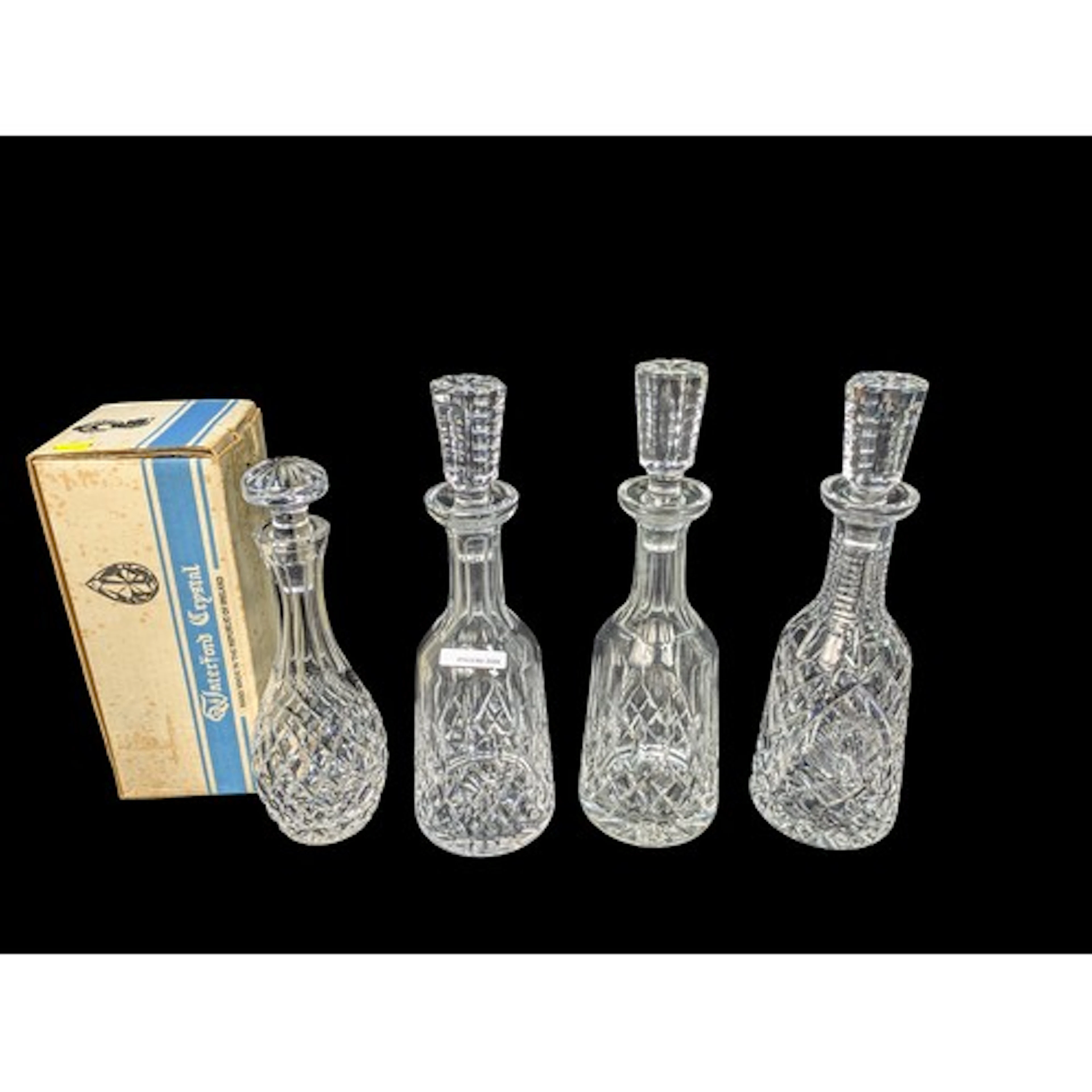 Four Waterford cut-glass decanters with diamond, fan and sta...