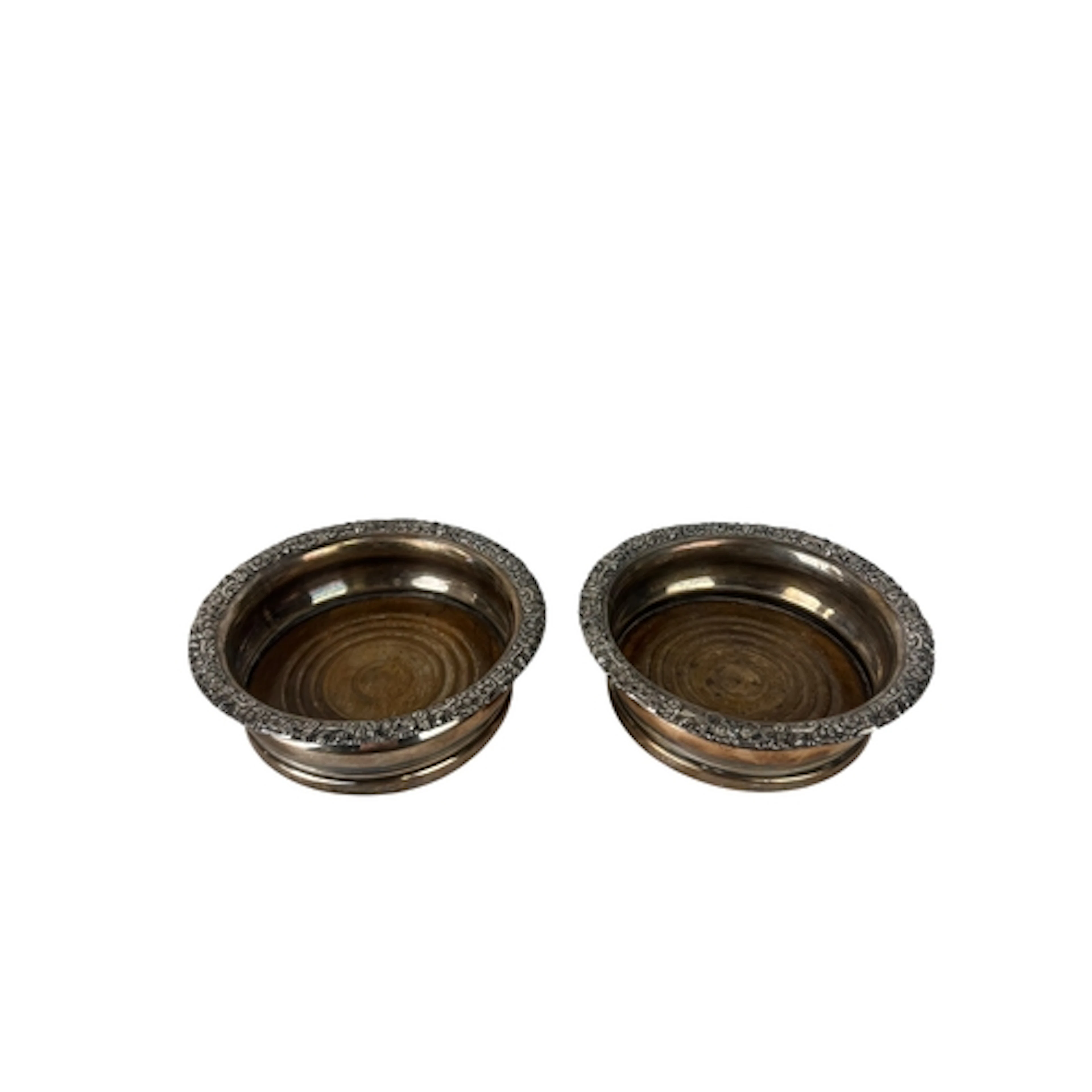 A PAIR OF WHITE METAL WINE BOTTLE COASTERS 16cm D...