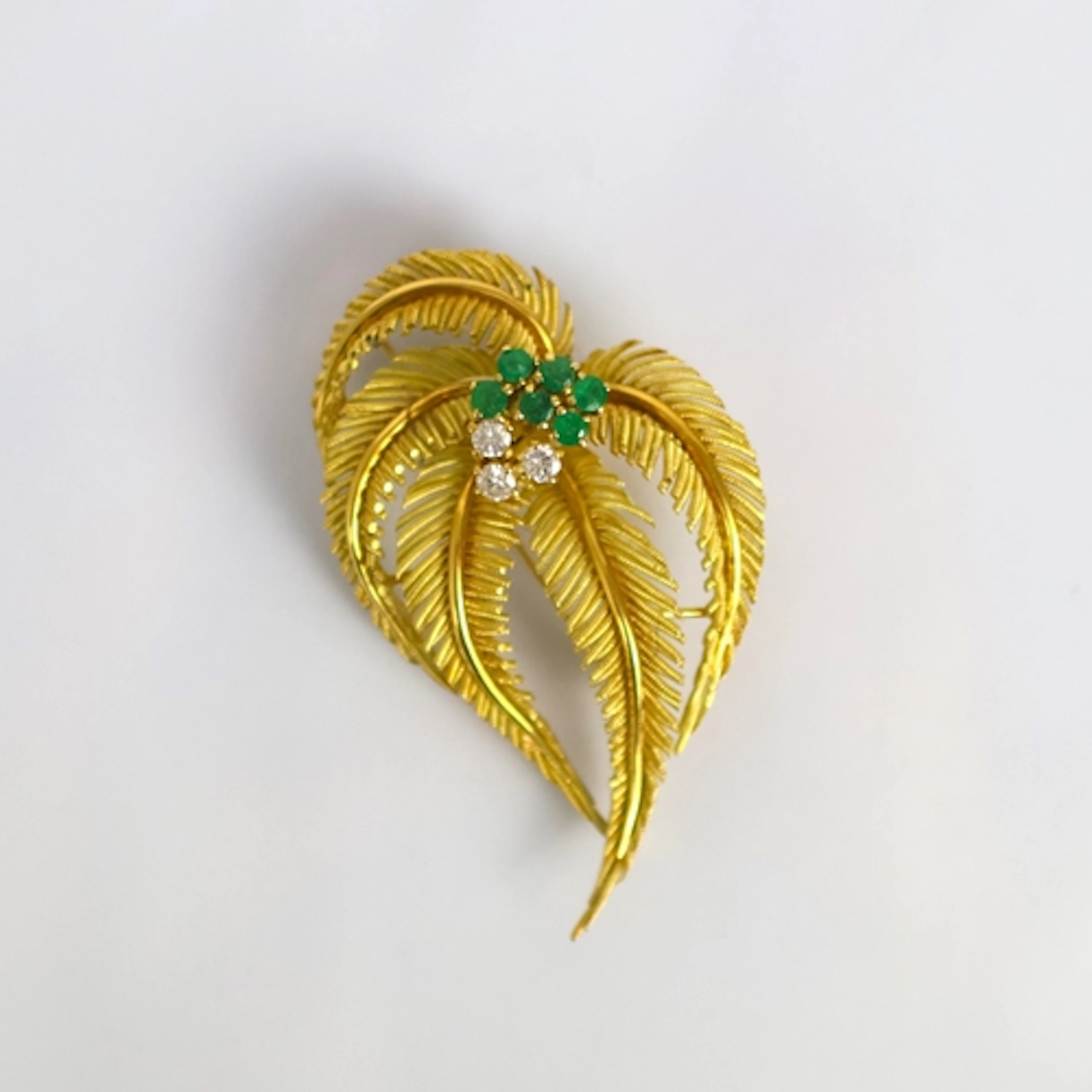 A late 20th century emerald and diamond stylised spray brooc...