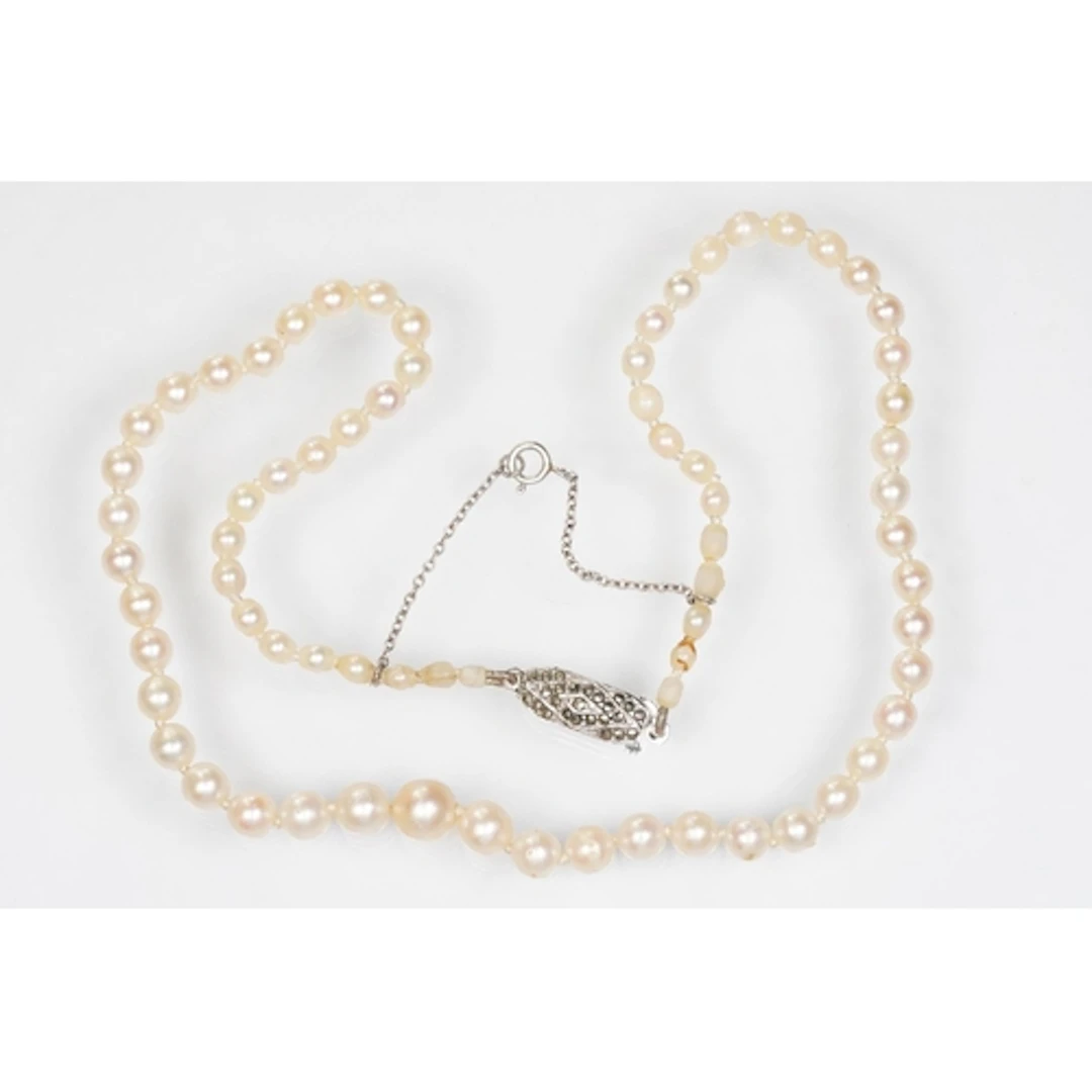 Pearl necklace having a silver and marcasite set clasp. The ...