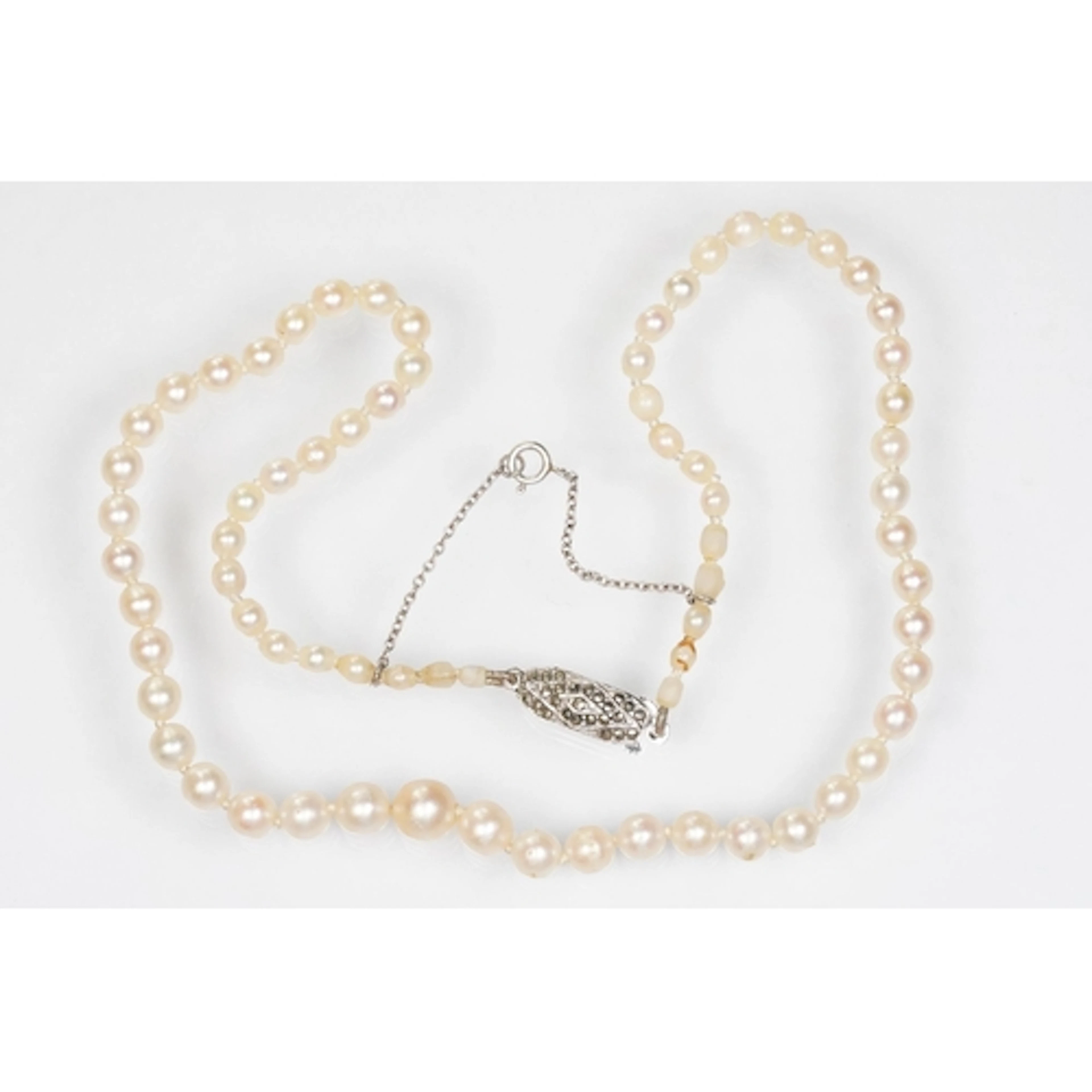 Pearl necklace having a silver and marcasite set clasp. The ...