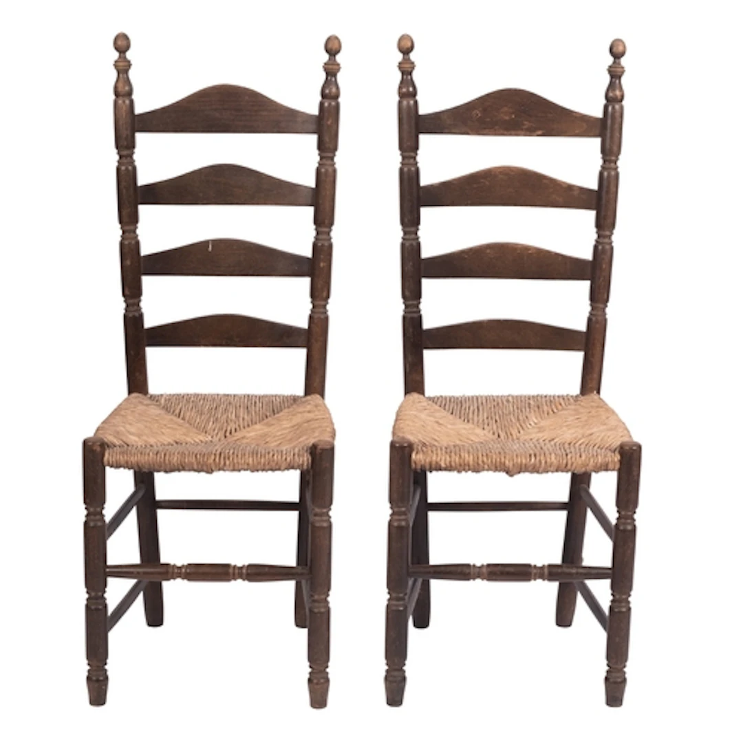 A pair of stained hardwood and rush seated side chairs, in e...