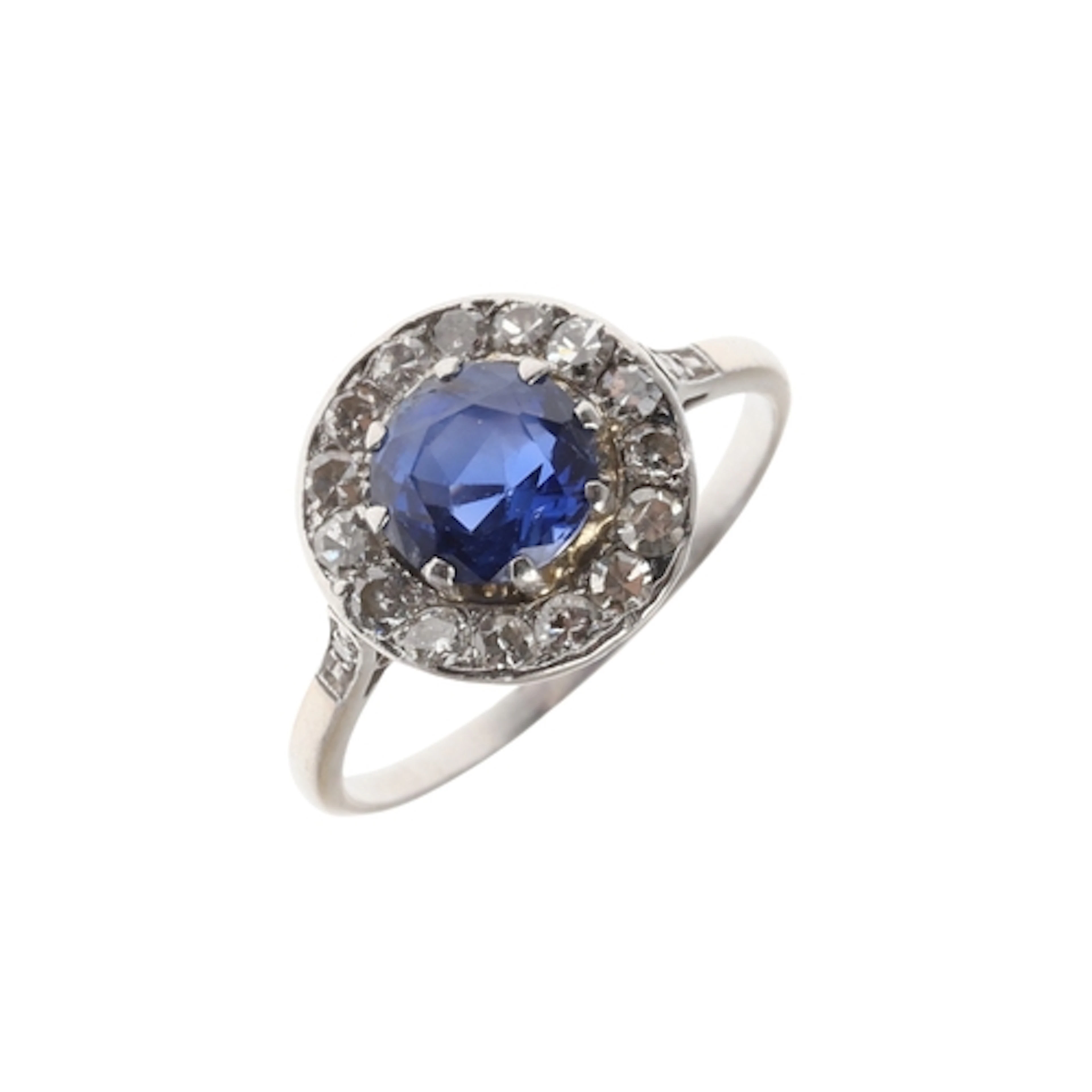 A SAPPHIRE AND DIAMOND CLUSTER RING. the circular-cut sapphi...