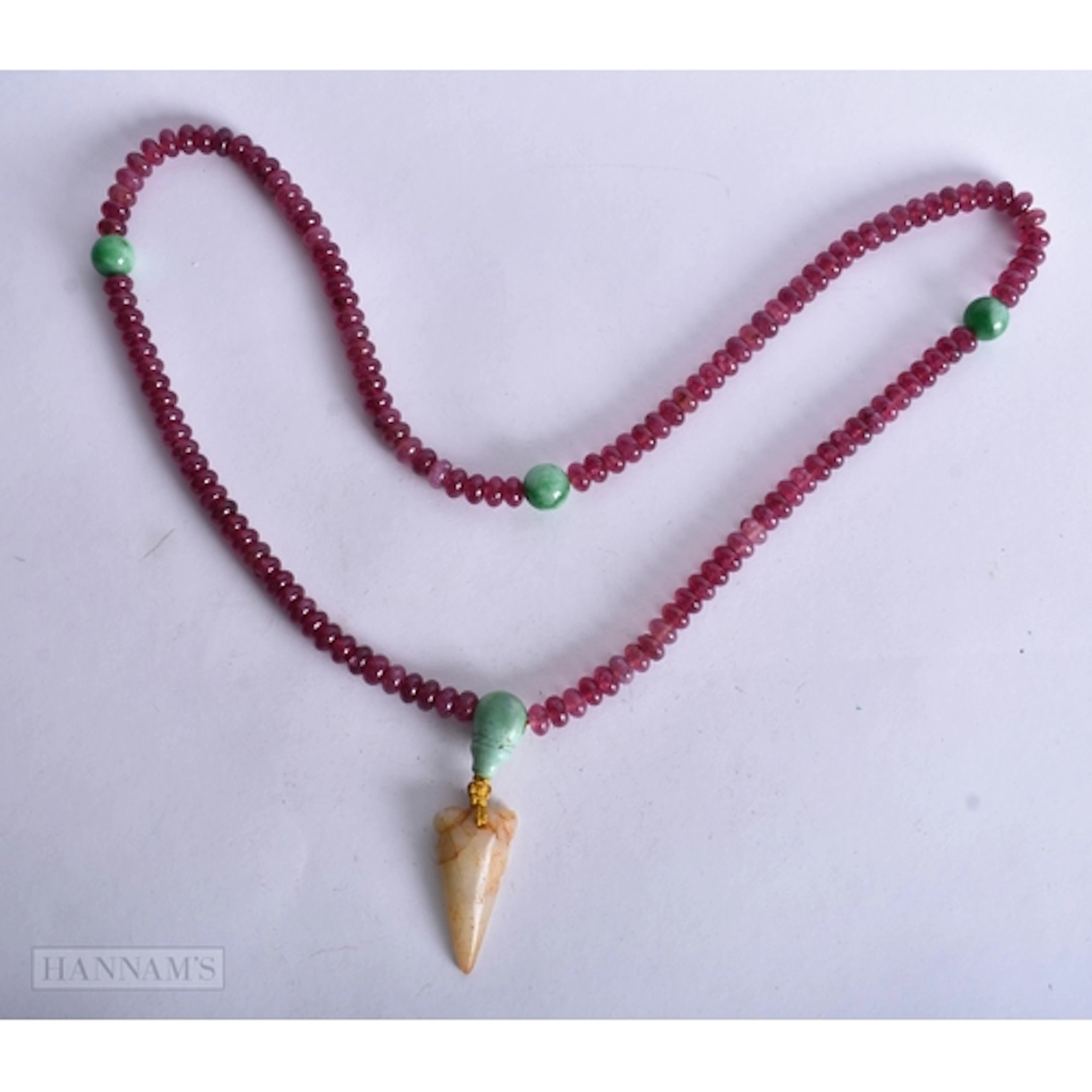 A CHINESE CARVED TOURMALINE NECKLACE. 70 cm long.