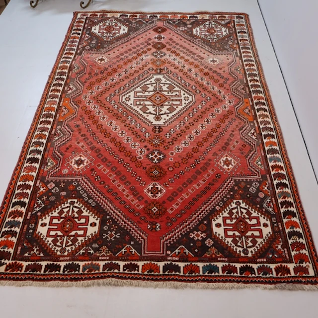 A large red ground Qashqai rug, L270cm, W161cm.