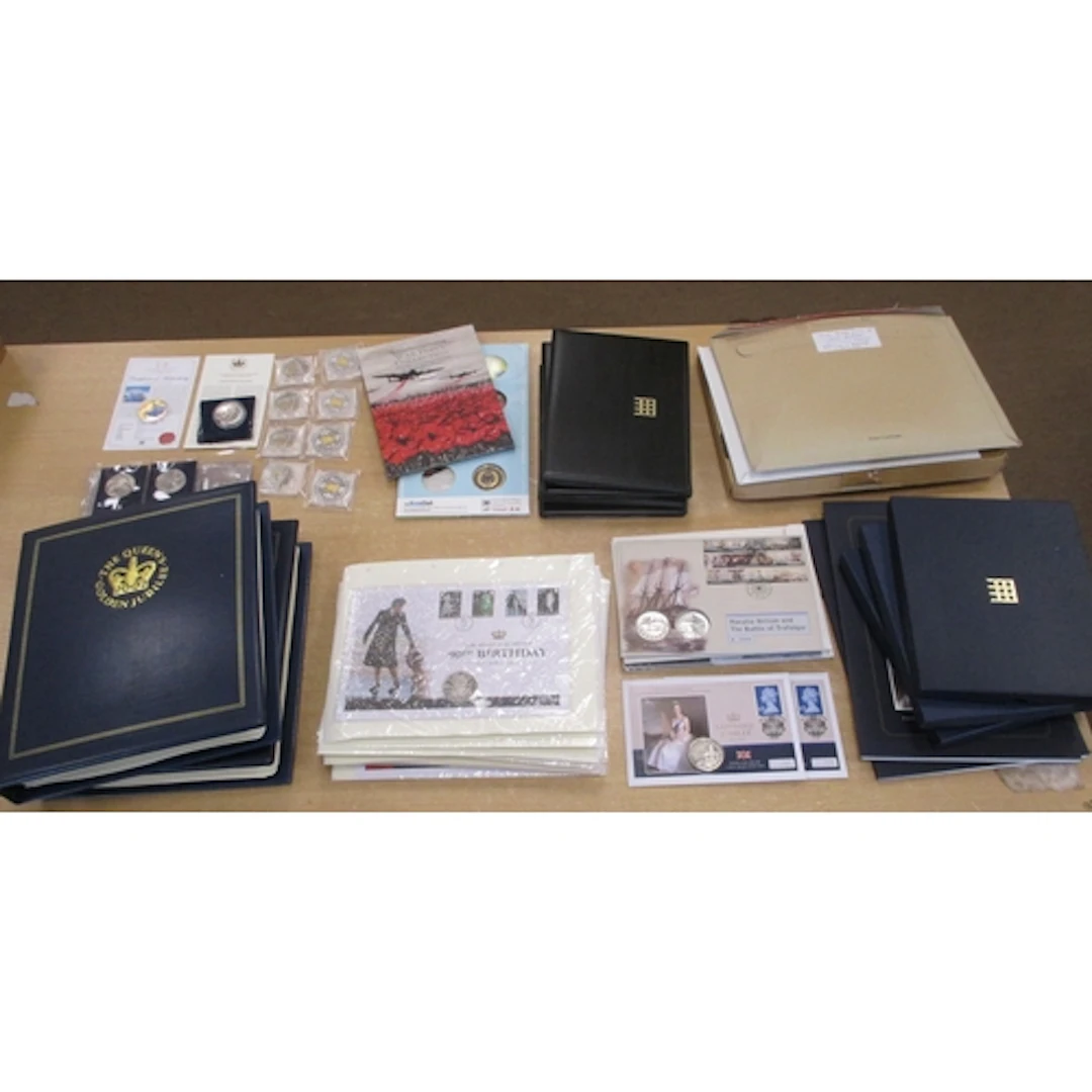 Collection of world uncirculated coin covers in albums (2) a...
