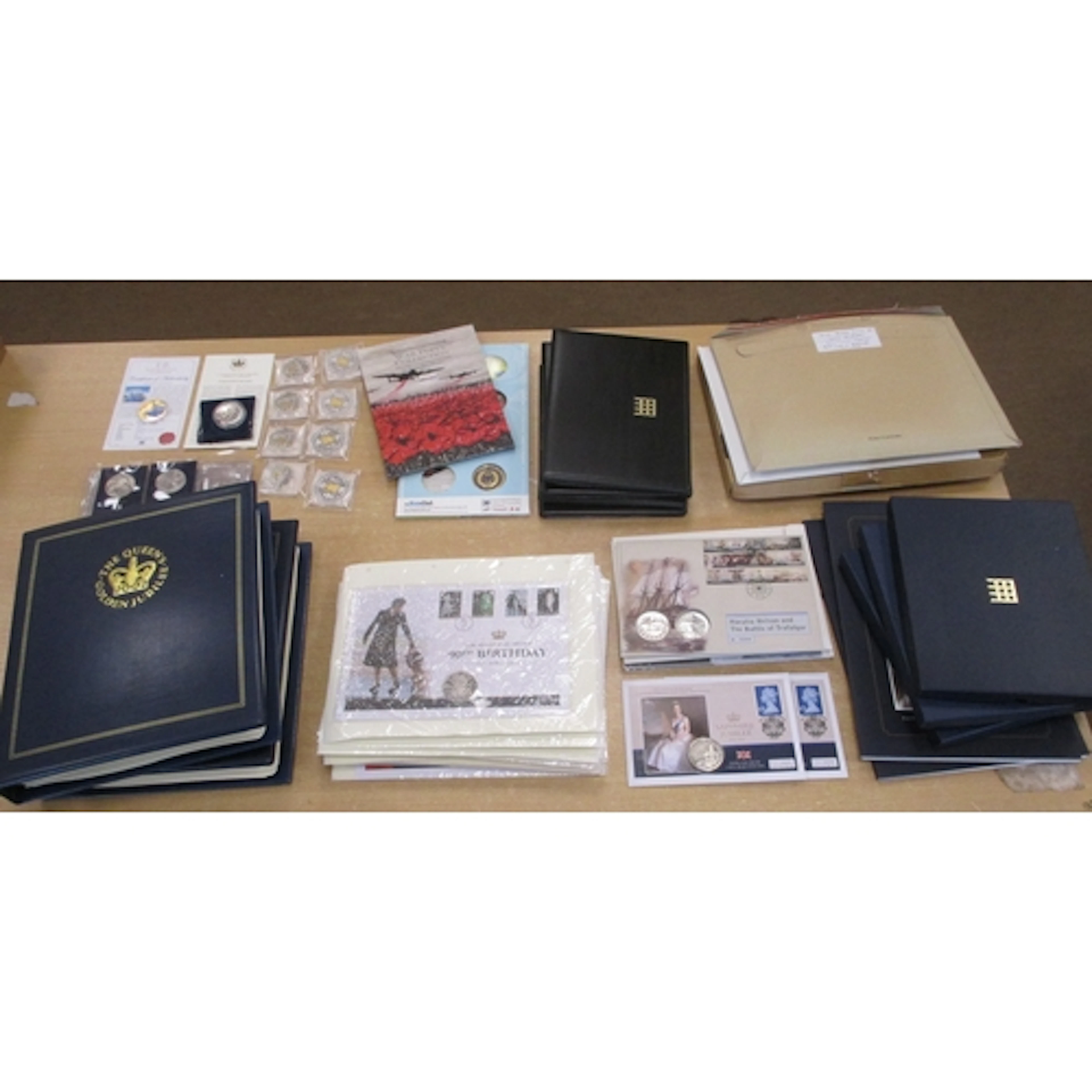 Collection of world uncirculated coin covers in albums (2) a...