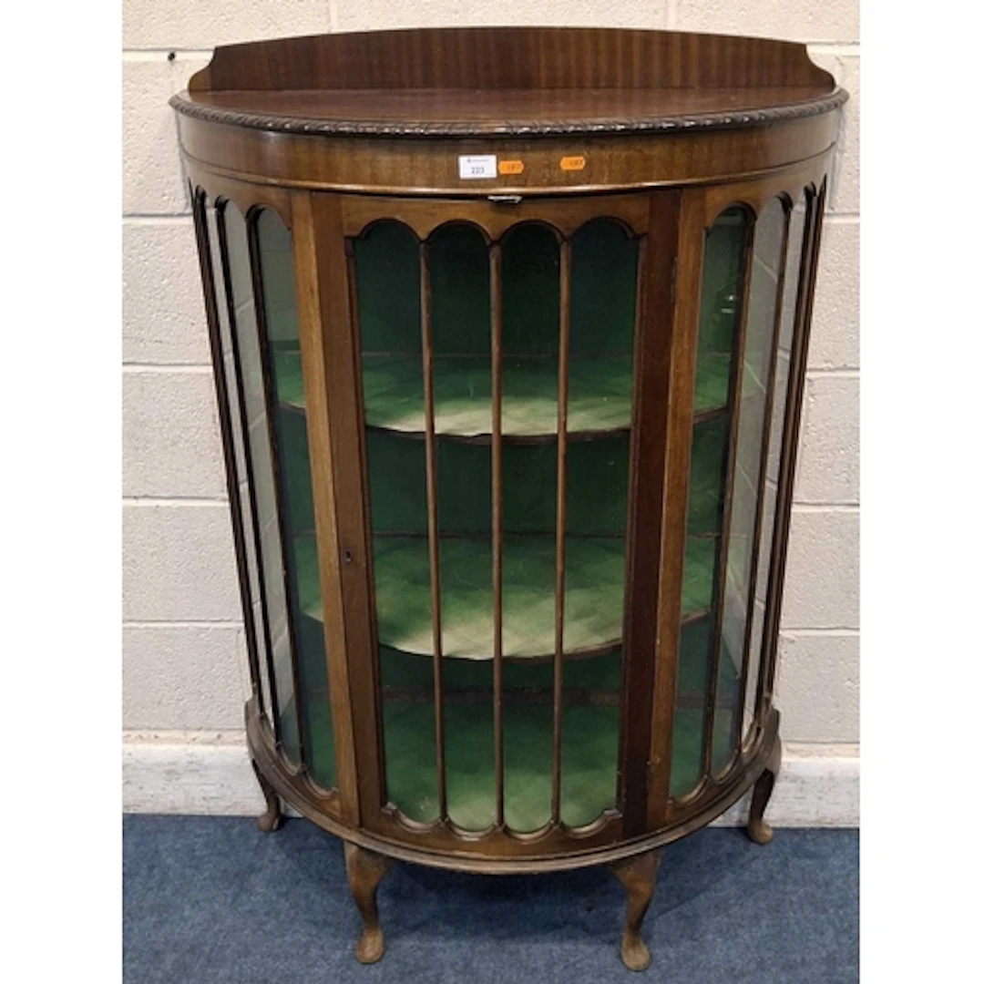 AN EDWARDIAN MAHOGANY DEMI-LUNE DISPLAY CABINET, the single ...