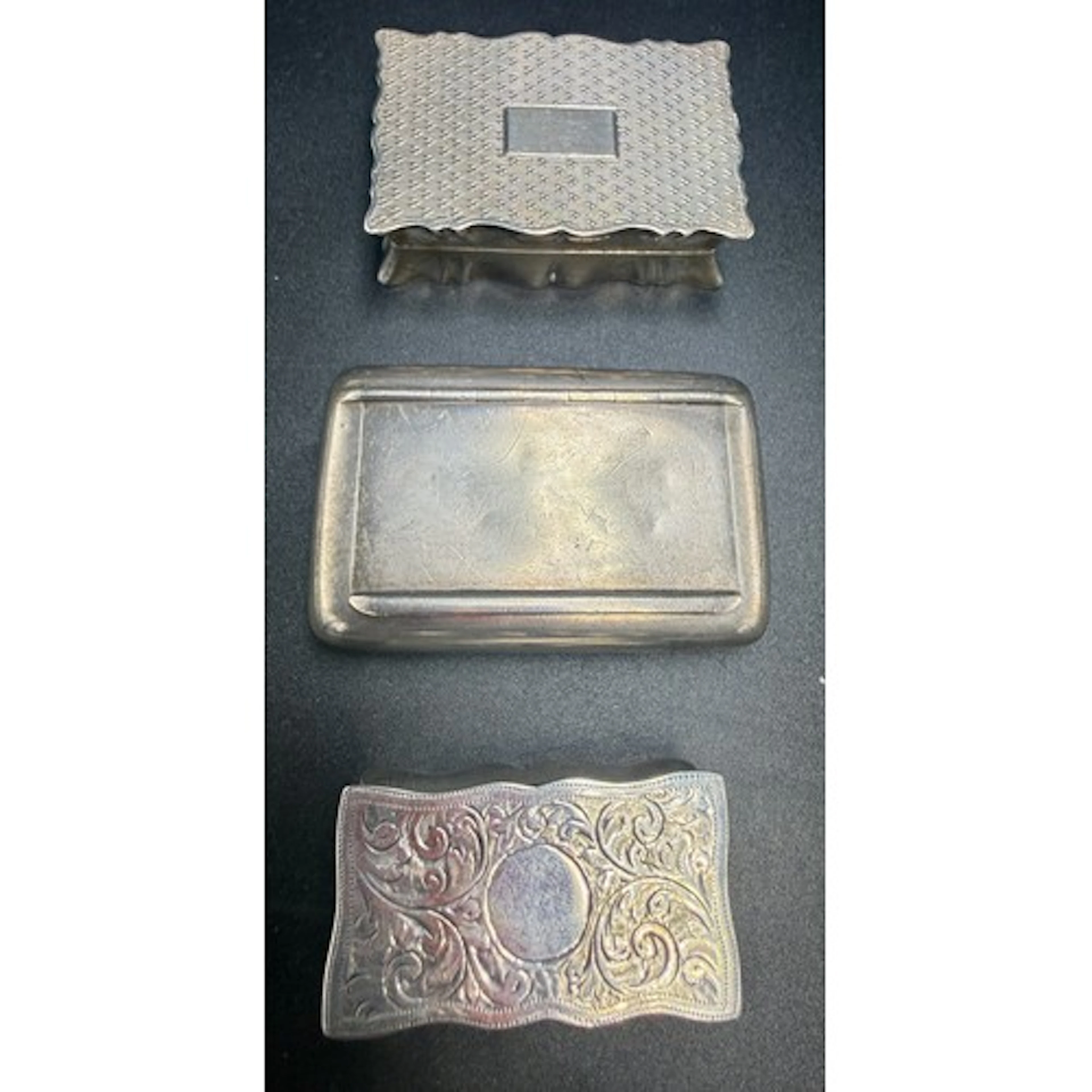 Three hallmarked silver snuff boxes to include Chester 1924,...