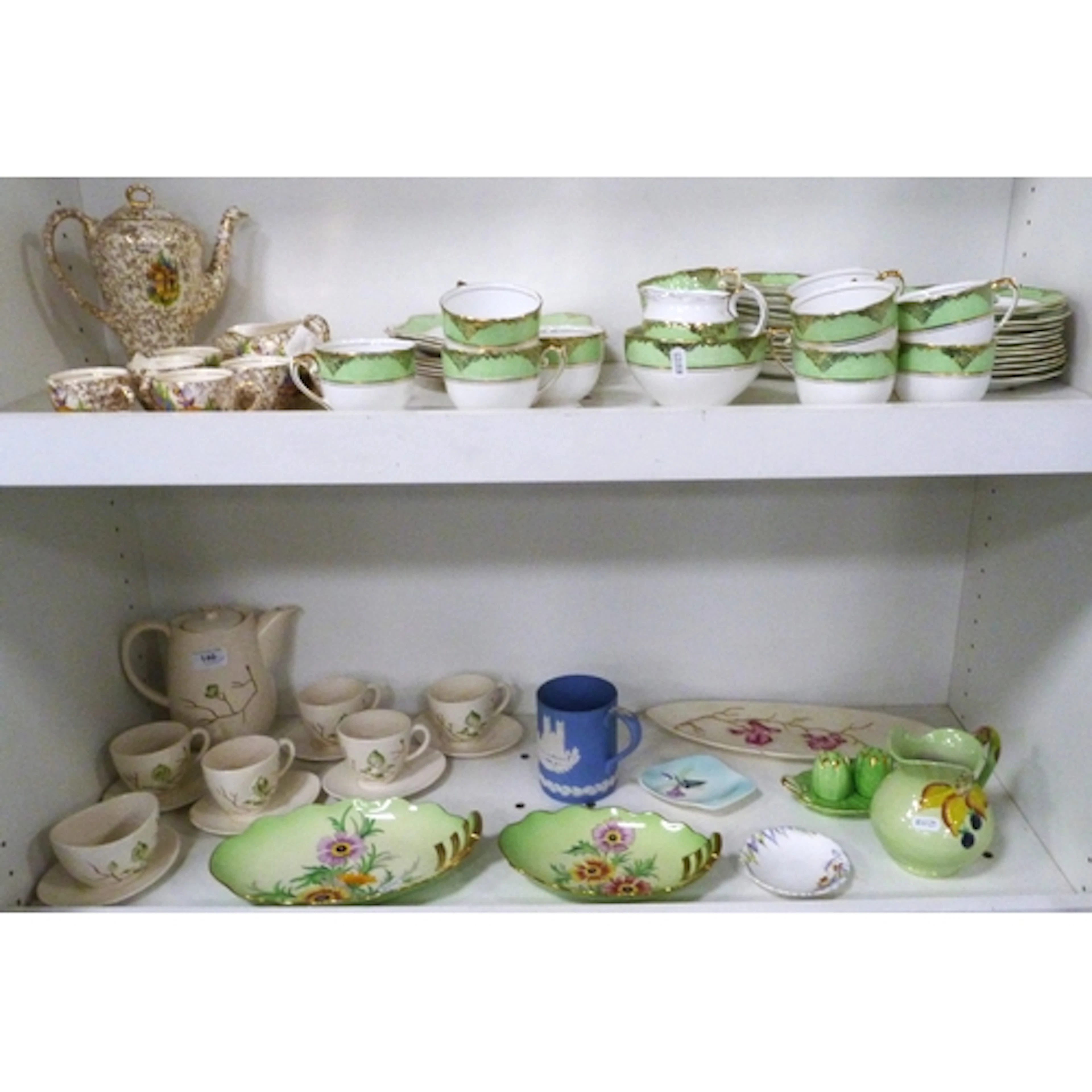 Two shelves of ceramics and tea china to include Carlton War...