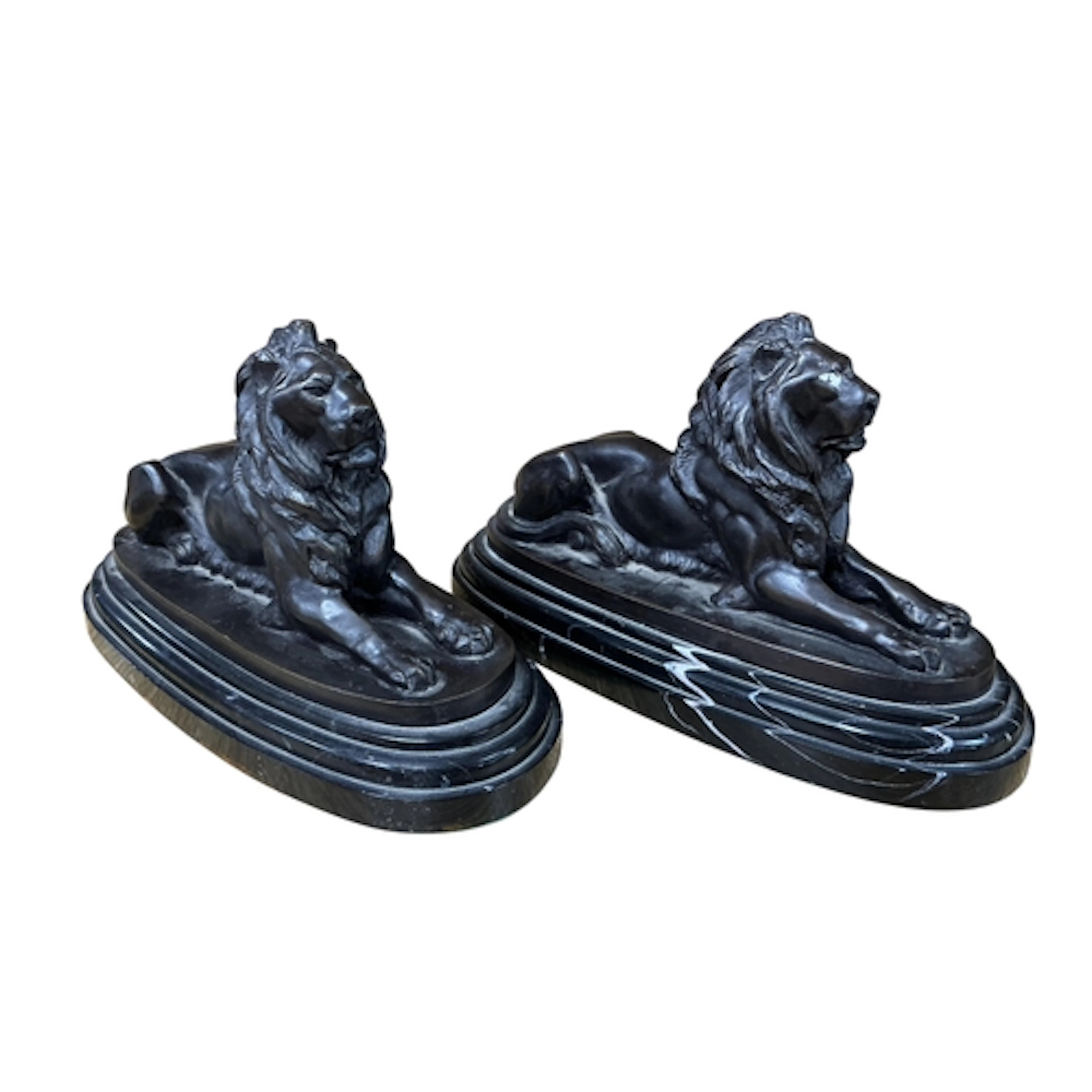 A pair of bronze recumbent lions, raised on marble bases, 29...