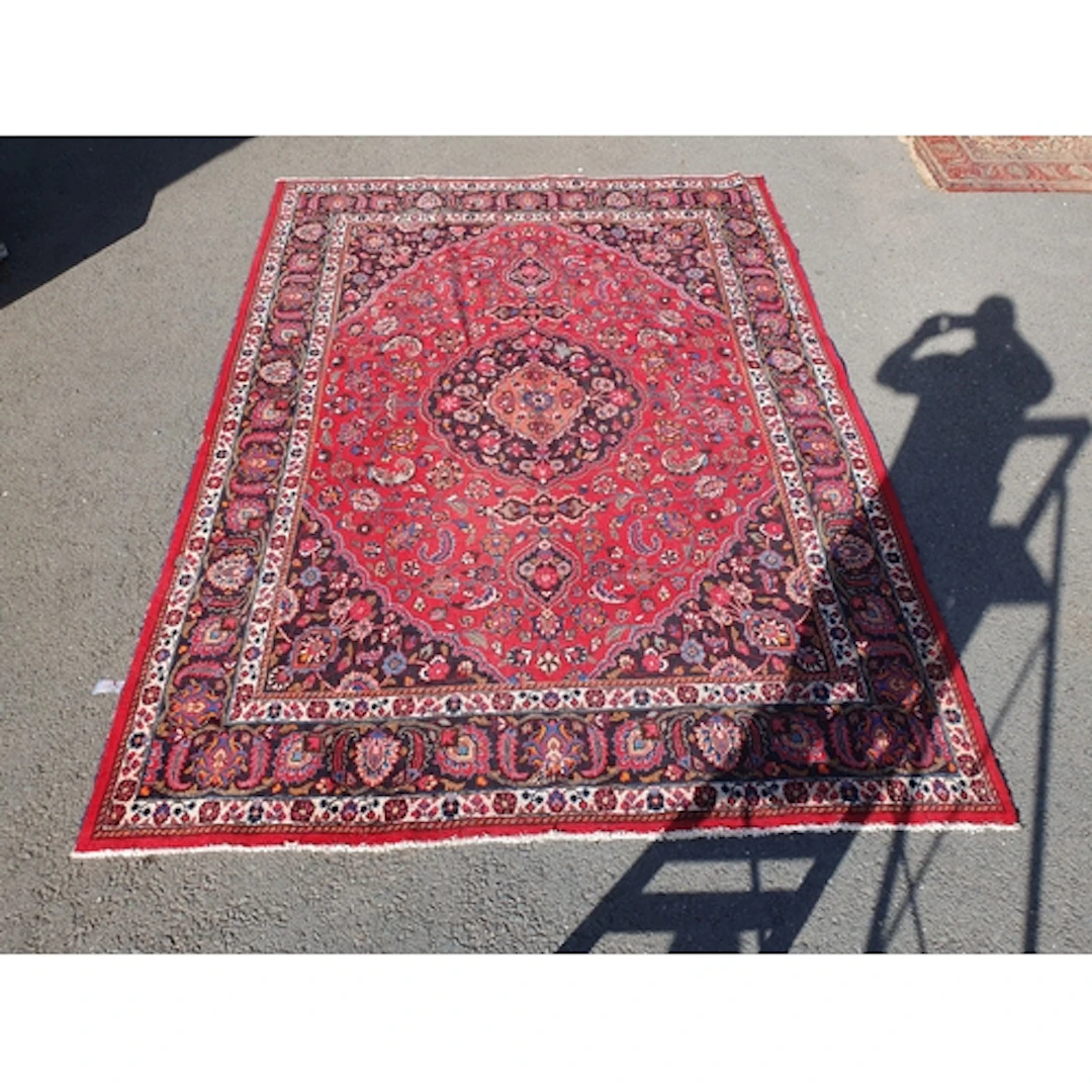 A Persian style Carpet on red ground, with multi borders and...
