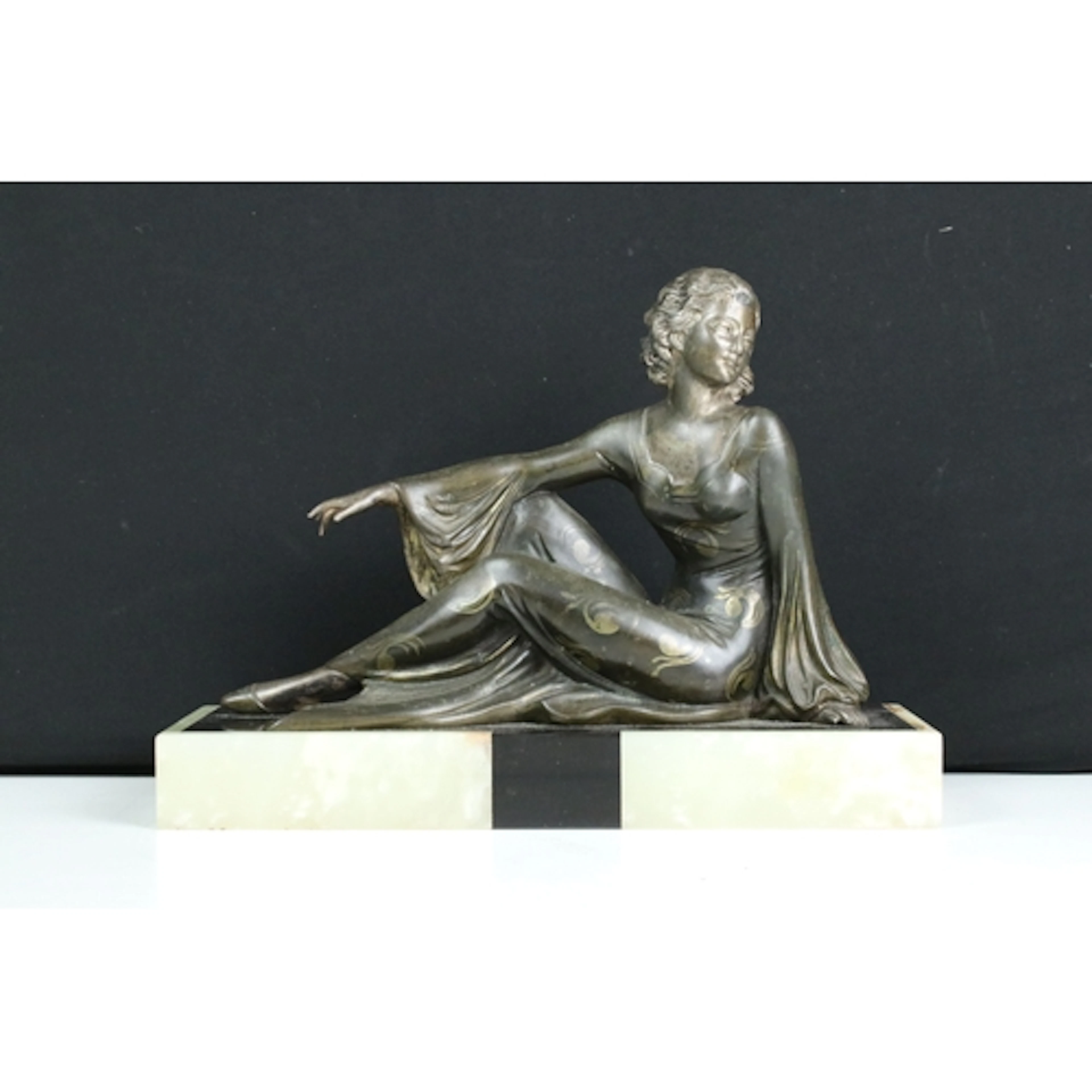 Art Deco bronze sculpture of a reclining woman with painted ...