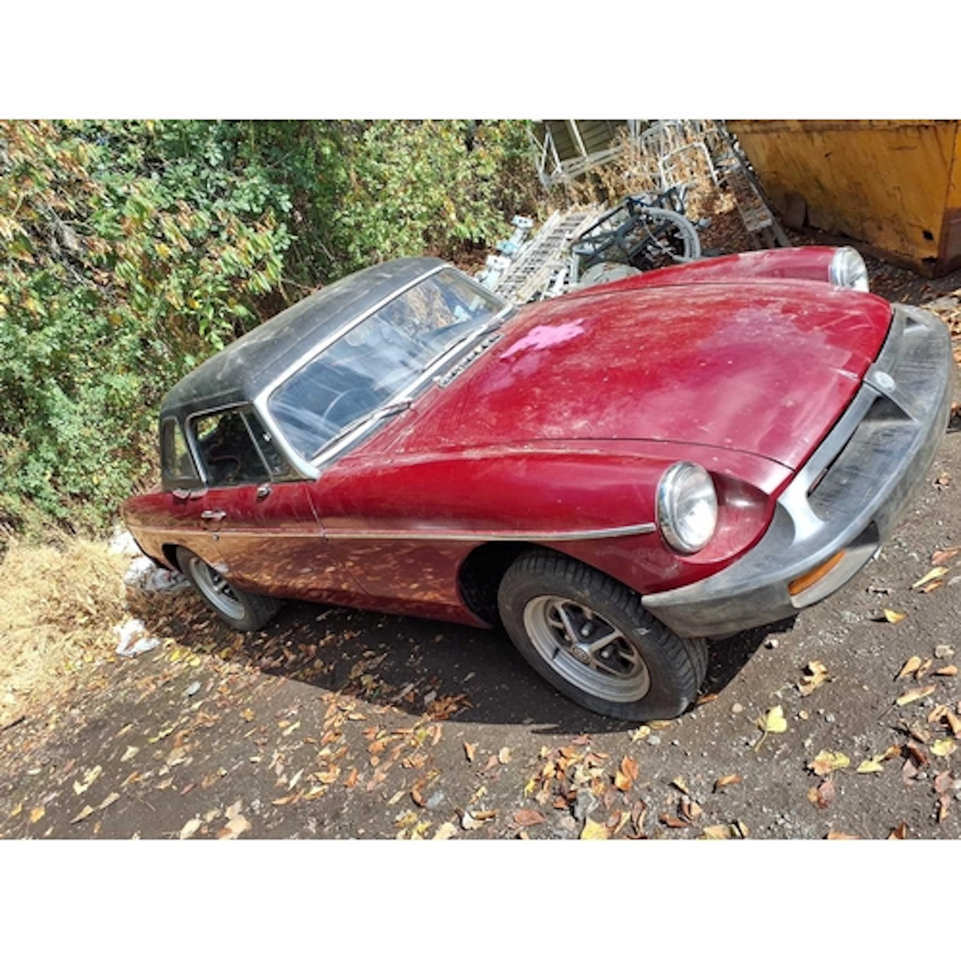 A 1977 MG B ROADSTER SPORTS CAR in red, with a 1798cc petrol...