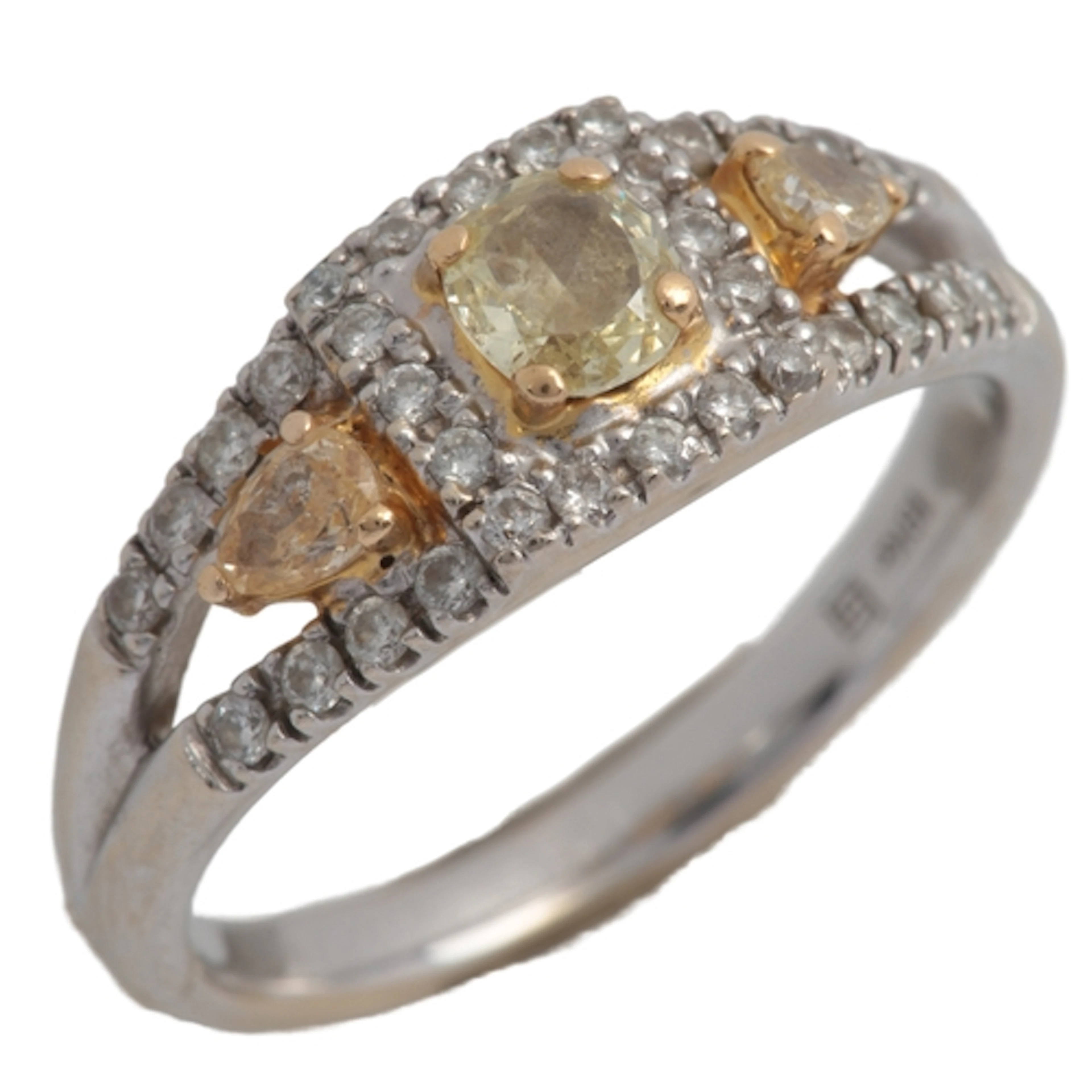 A yellow diamond and diamond ring, set with cushion- and pea...