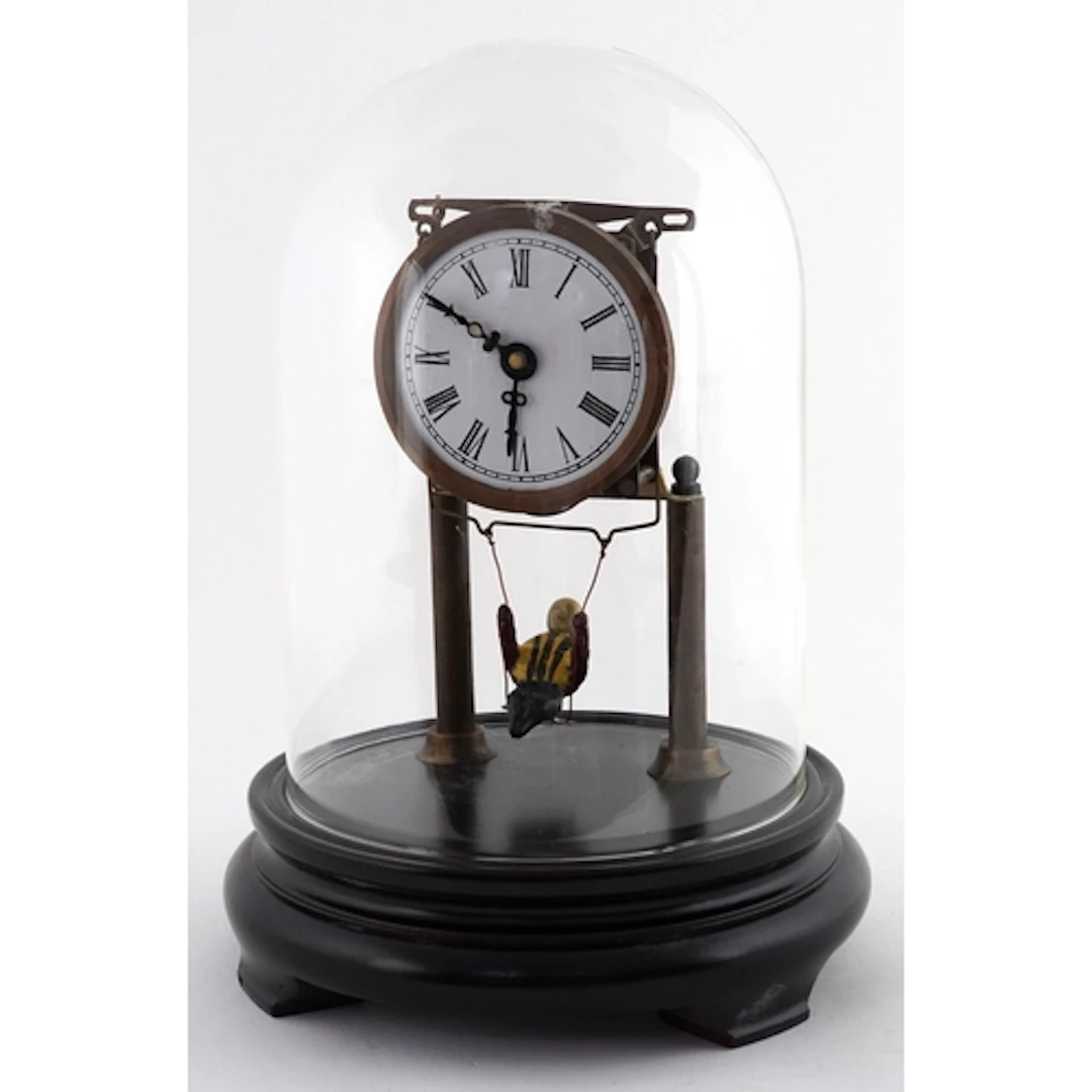 Novelty brass skeleton clock with swinging figure pendulum, ...