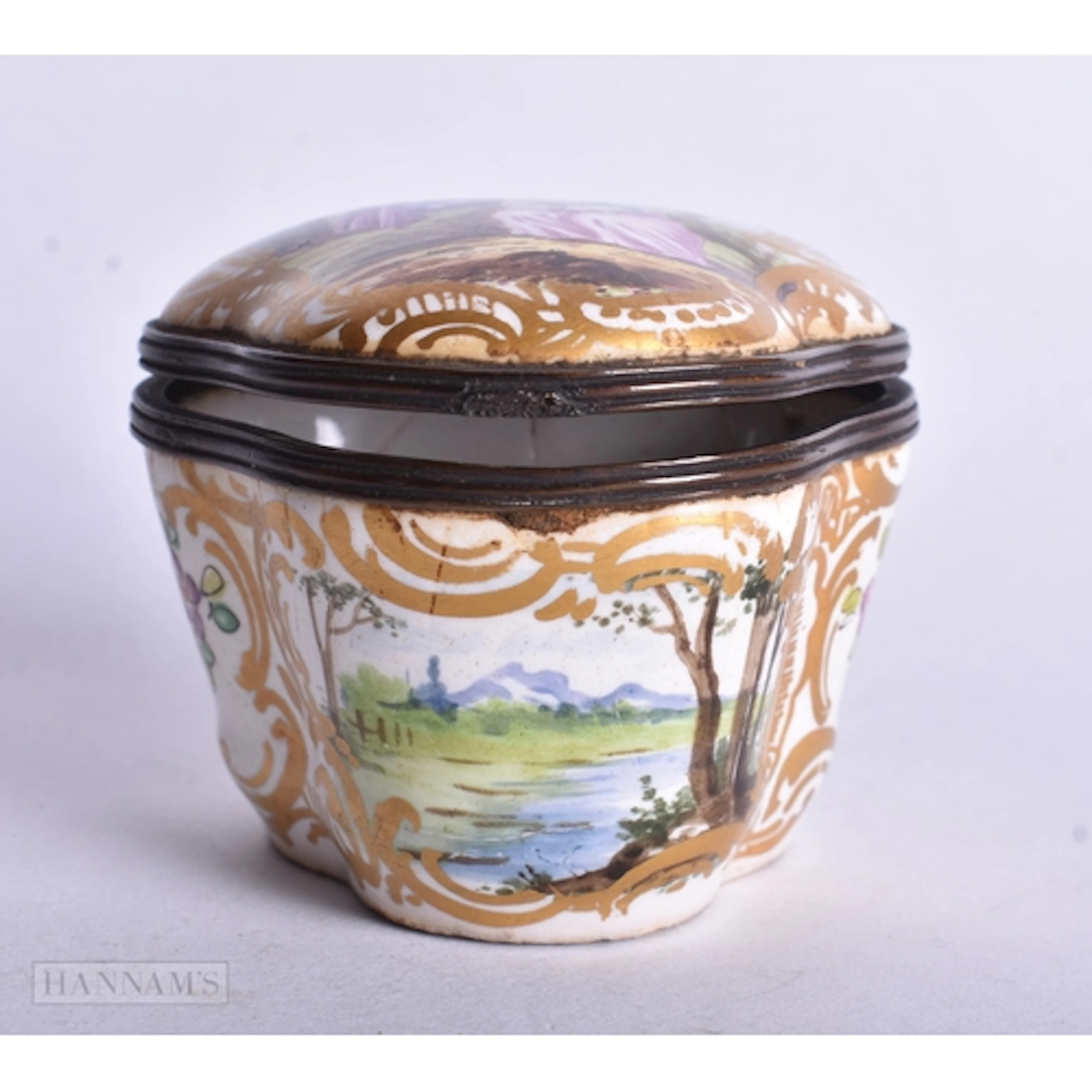 AN ANTIQUE PORCELAIN SNUFF BOX painted with figures in a lan...