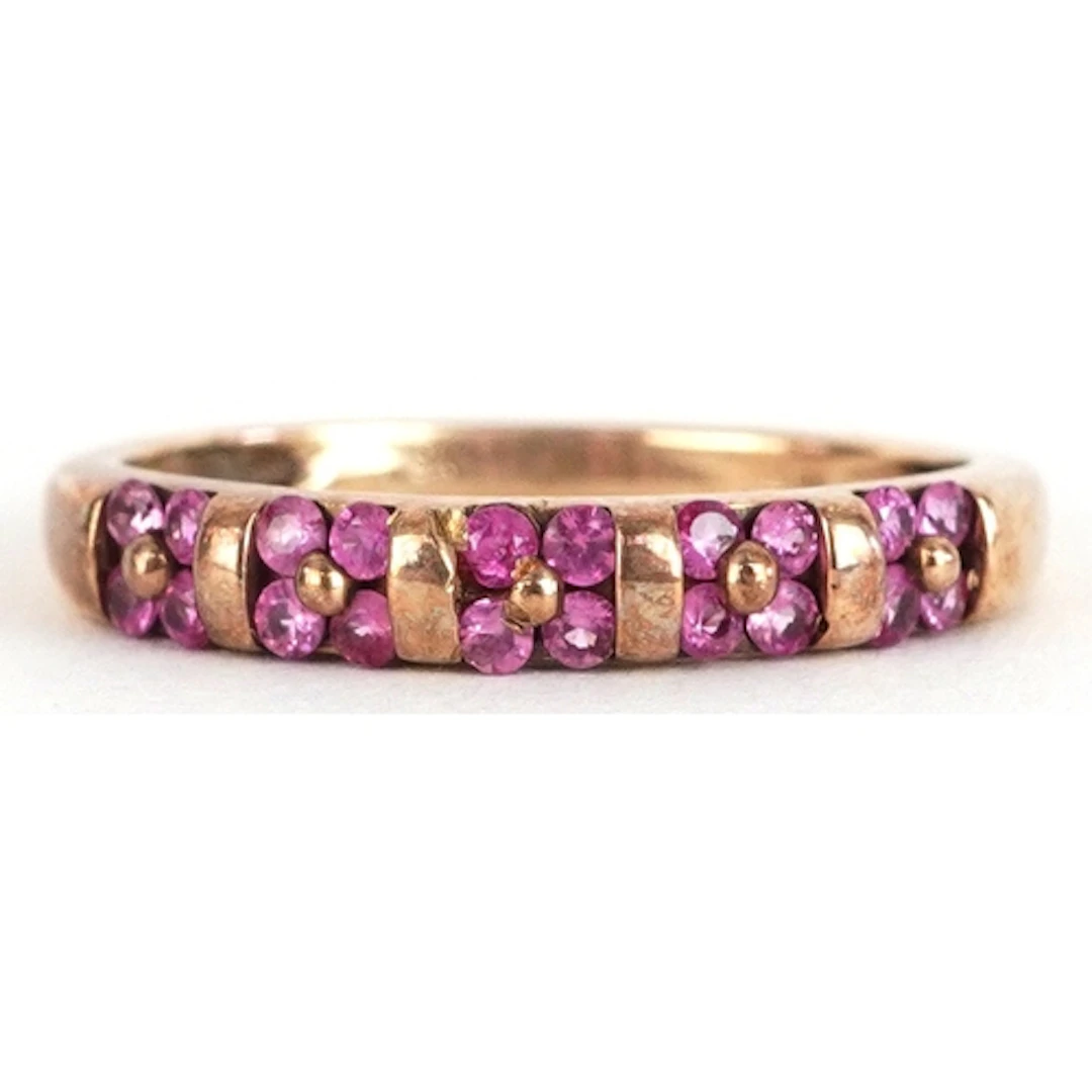 9ct gold ruby flower head half eternity ring, size Q, 1.9g.