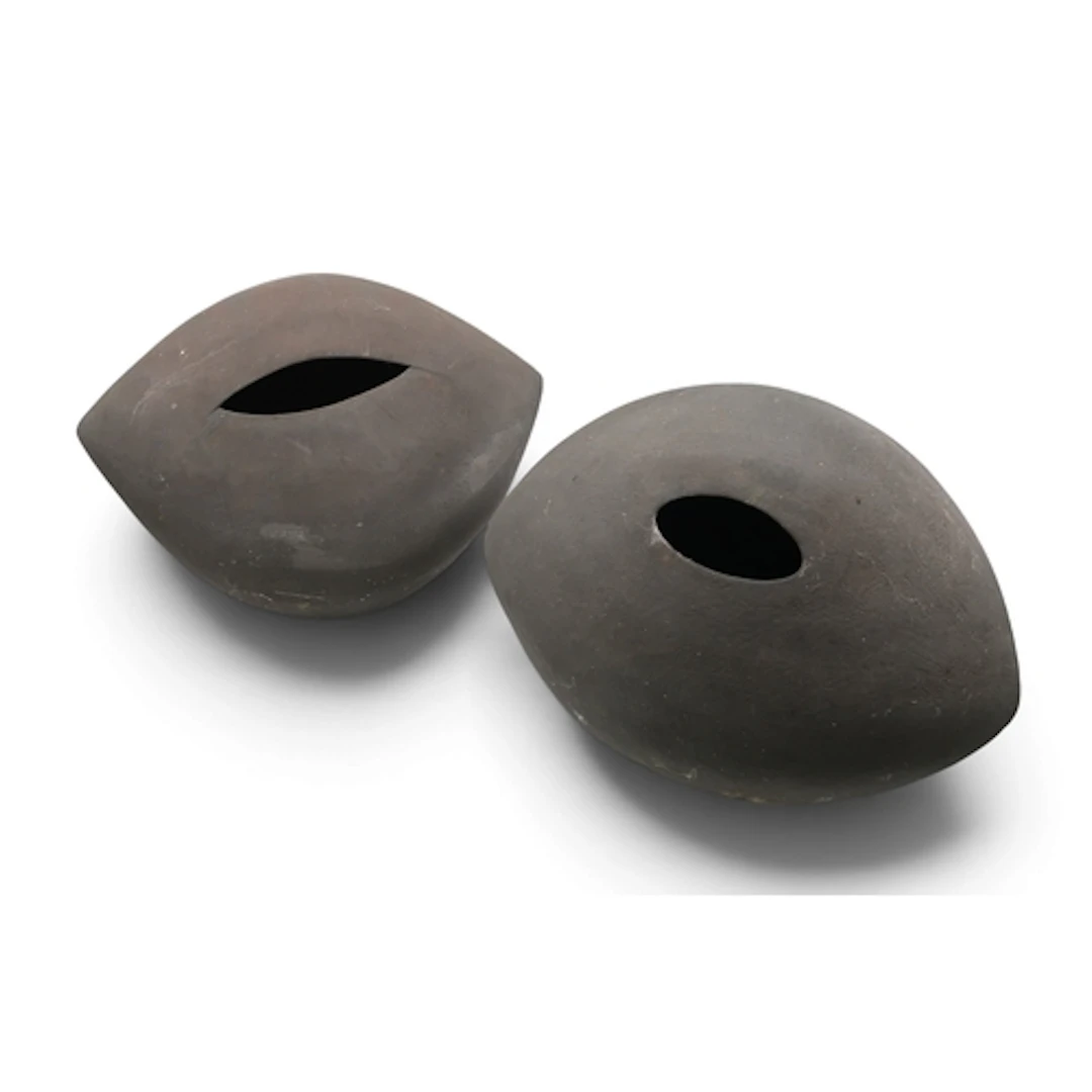 Two studio pottery pods with matt black glaze, one initialle...
