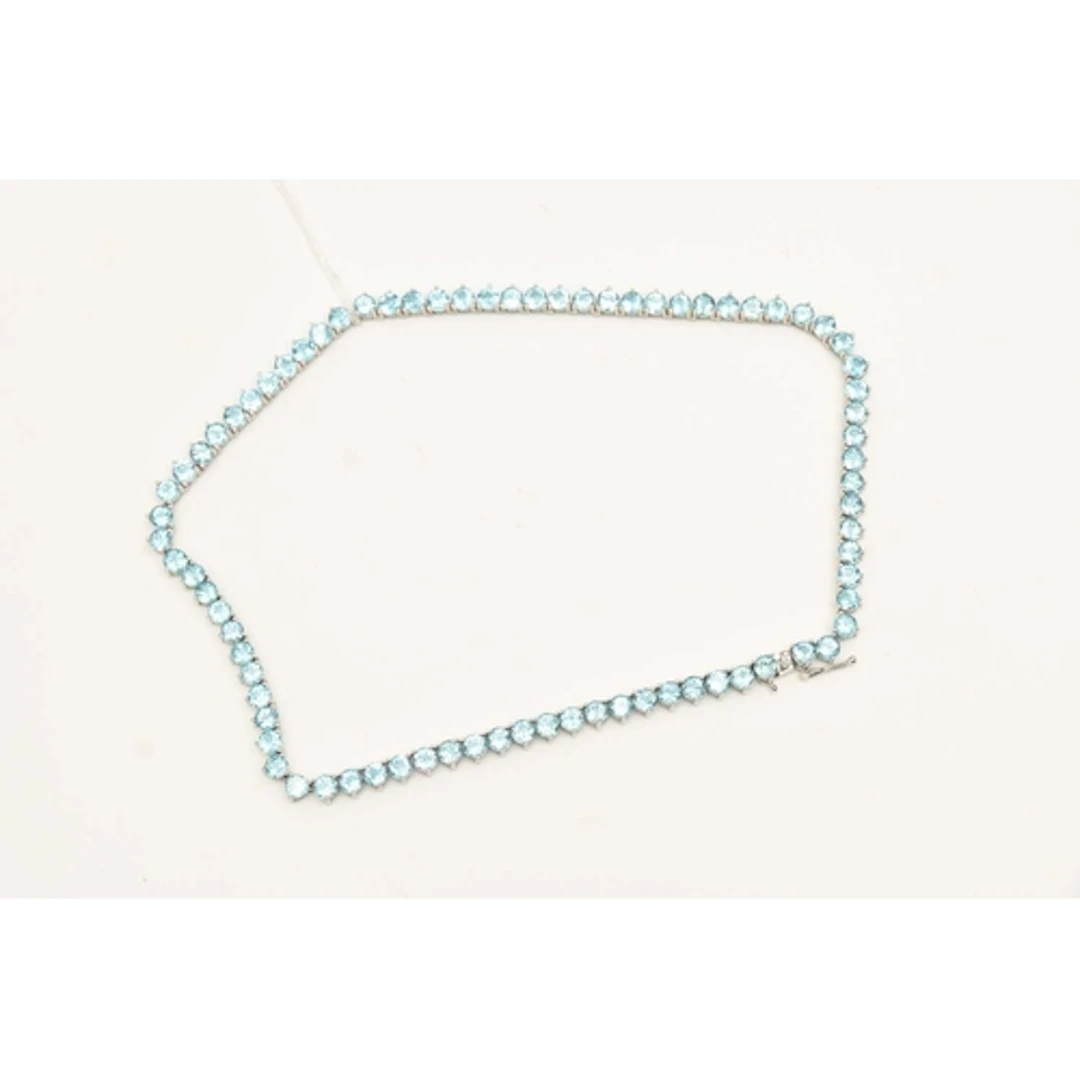 A WHITE METAL AND TOPAZ LINE NECKLACE, seventy nine circular...