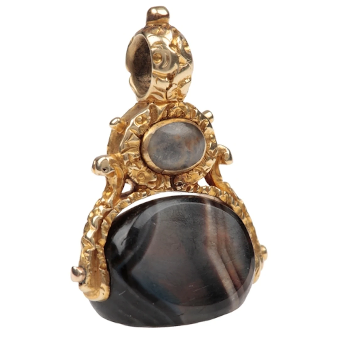 An unusual sentimental gold and onyx fob seal, circa 1830, s...