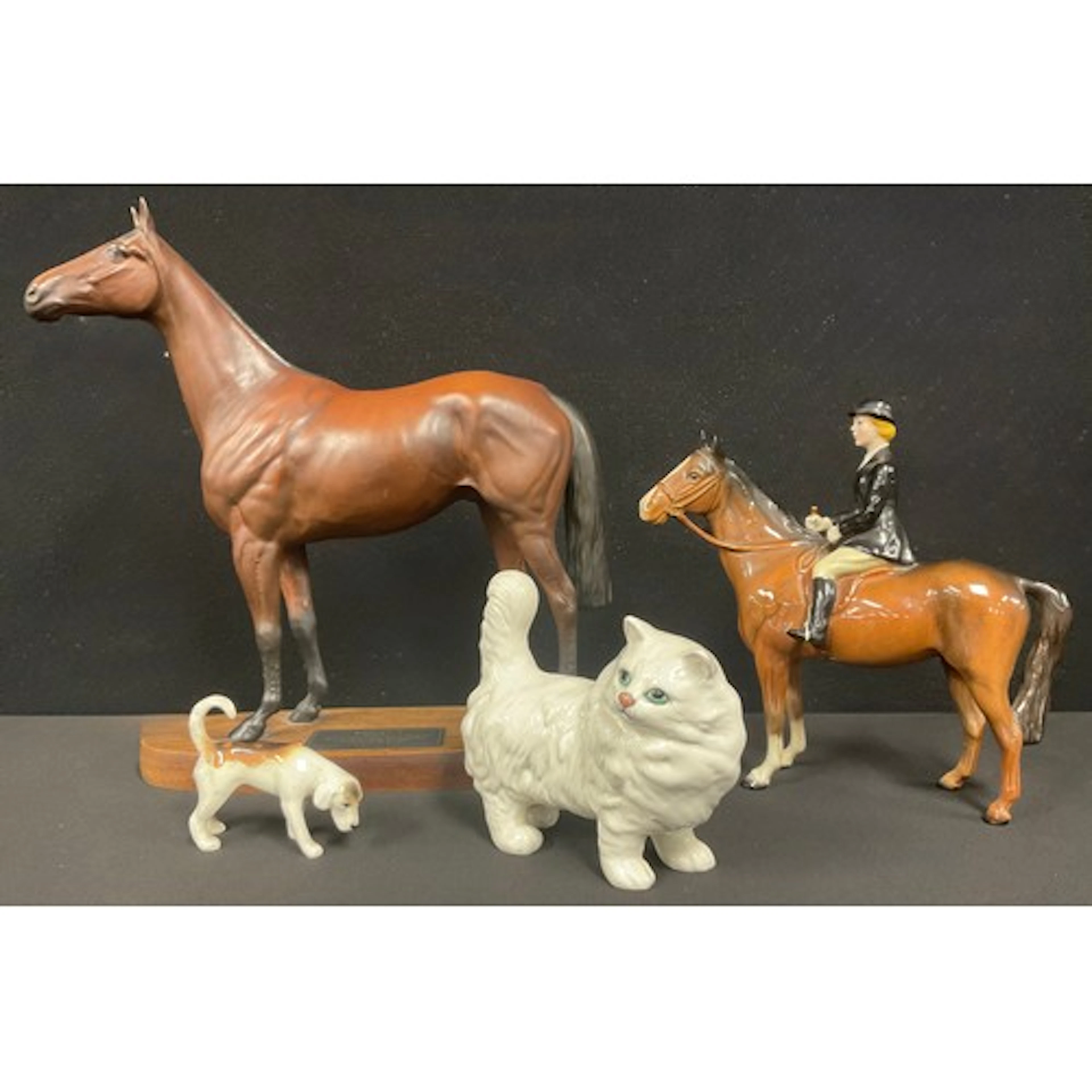 A Beswick figure, Huntswoman up, black gloss jacket, brown h...