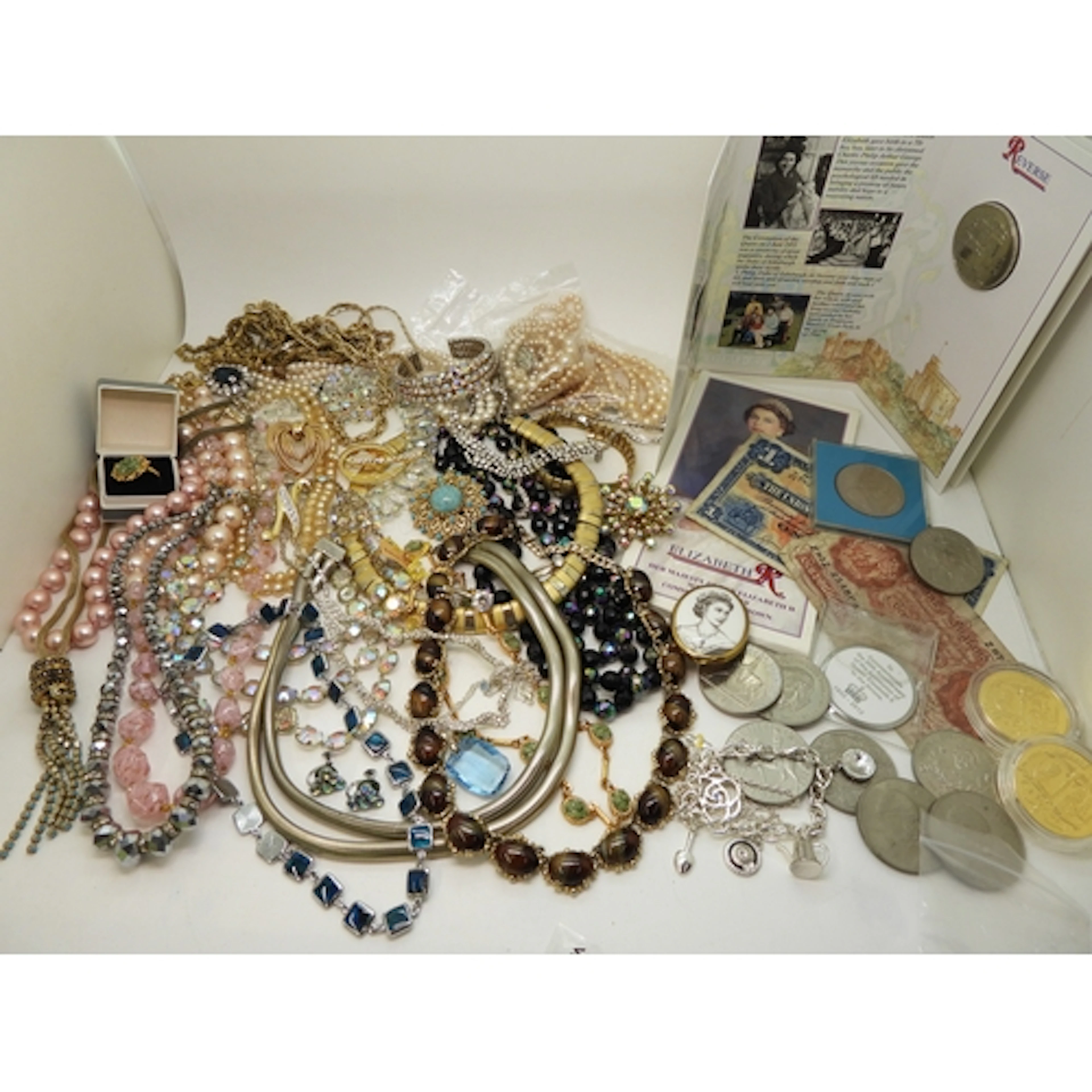 A string of peacock beads, a string of pink gold stone swirl...
