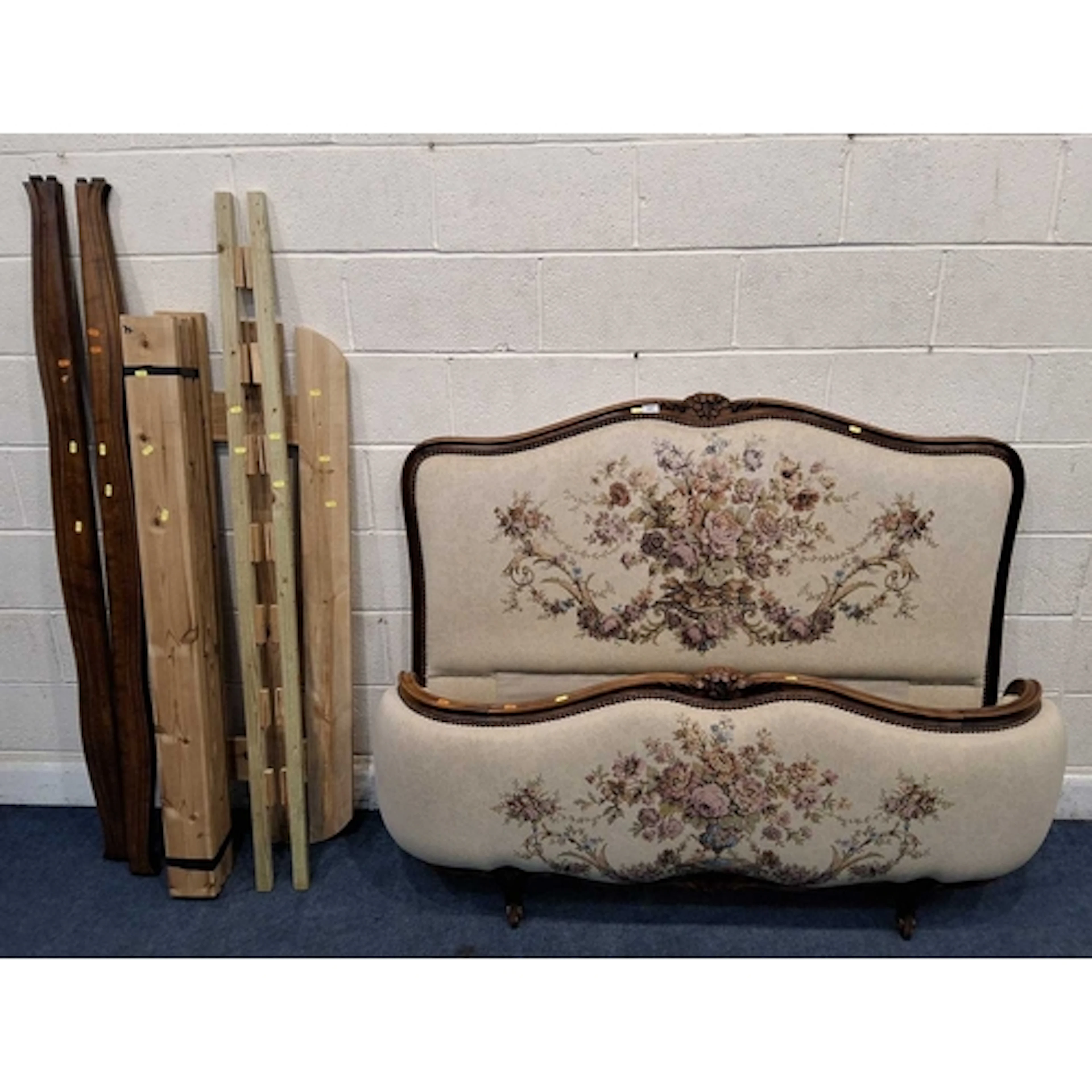 A FRENCH 4FT6 BEDSTEAD, with beige and foliate upholstery g...