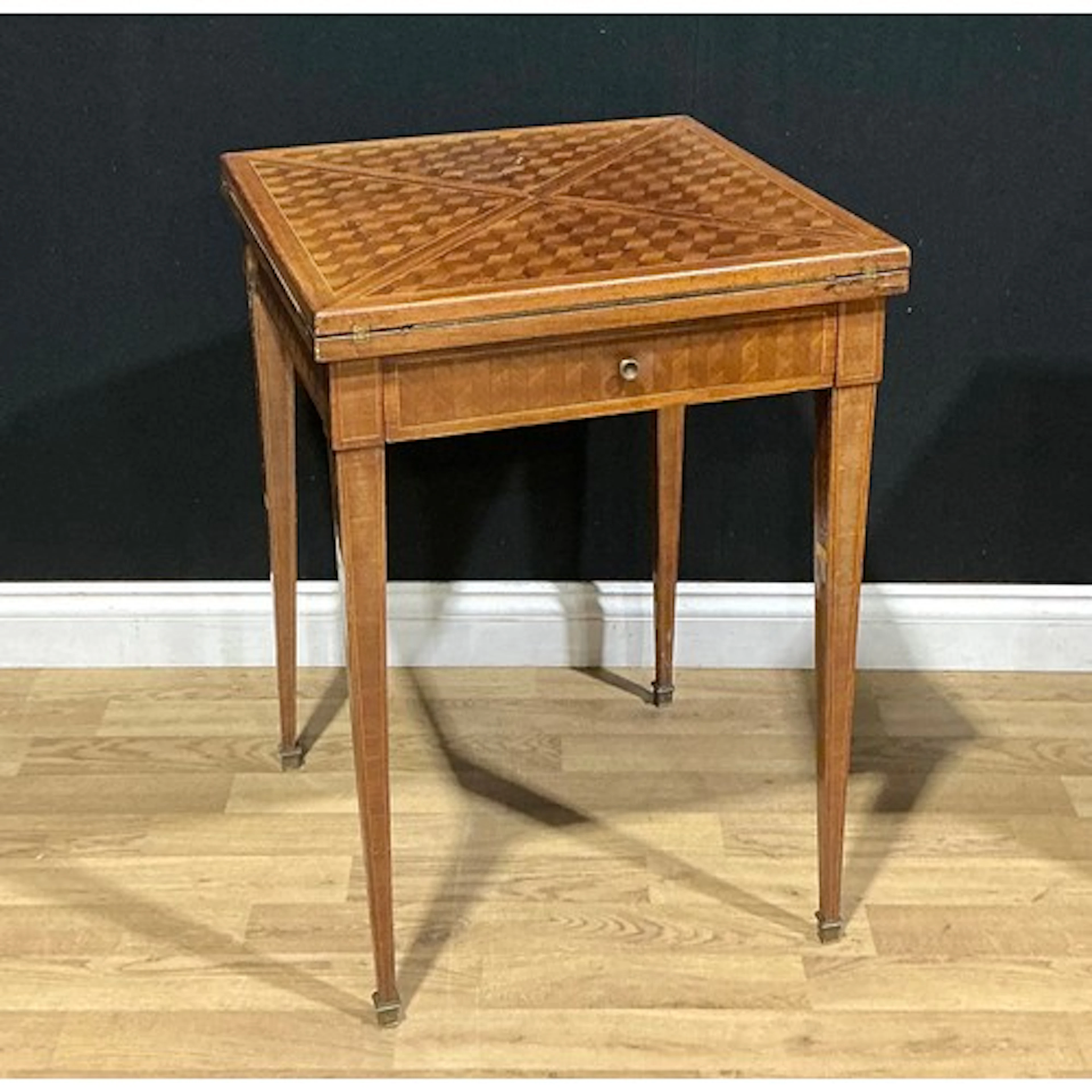 An early 20th century parquetry envelope card table, the top...