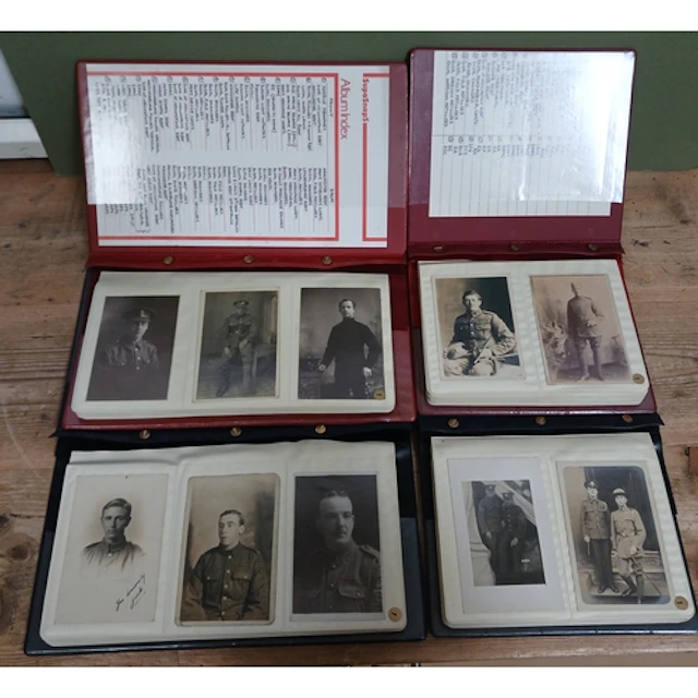 A group of four albums containing military portrait postcard...