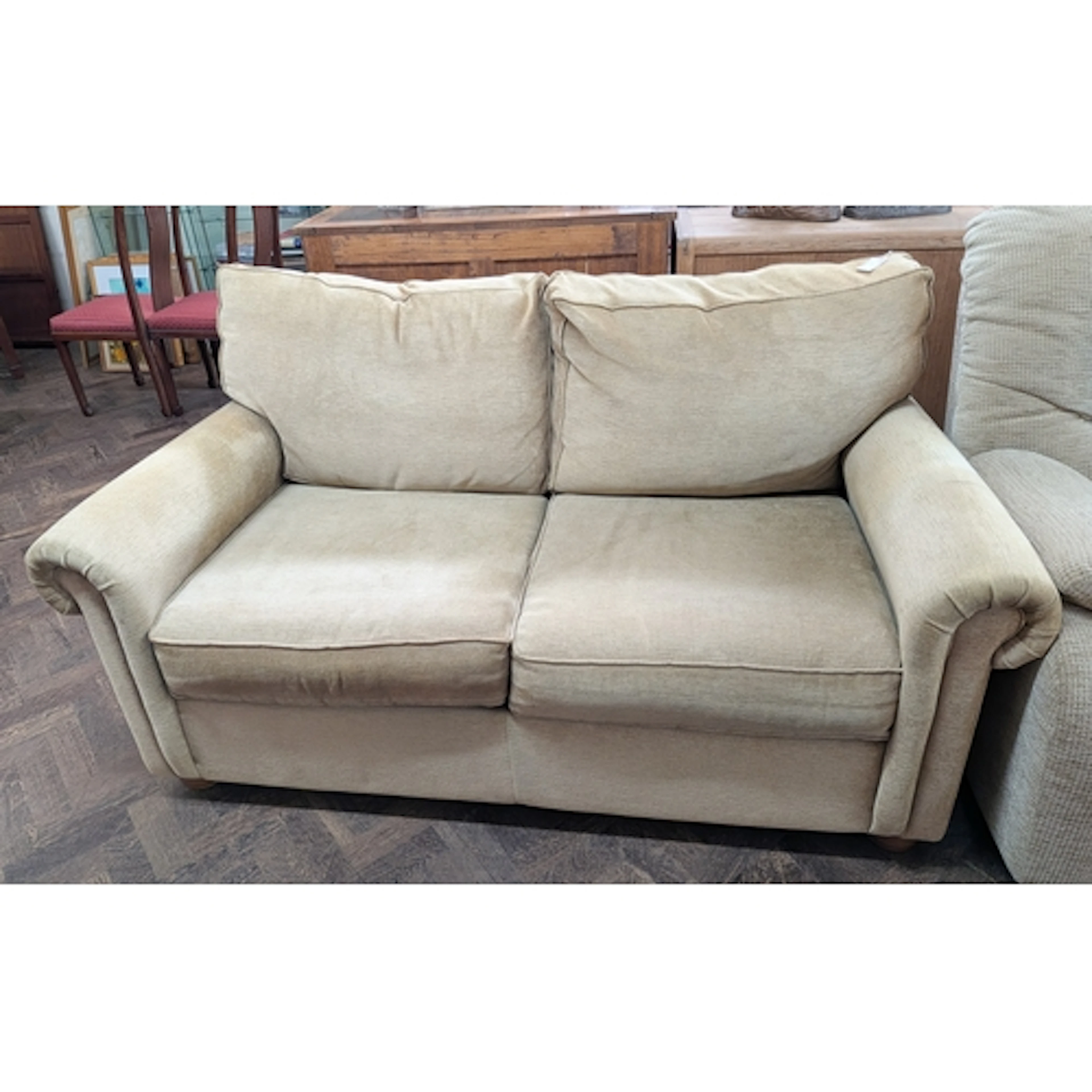 Modern two seater sofa upholstered in gold velour