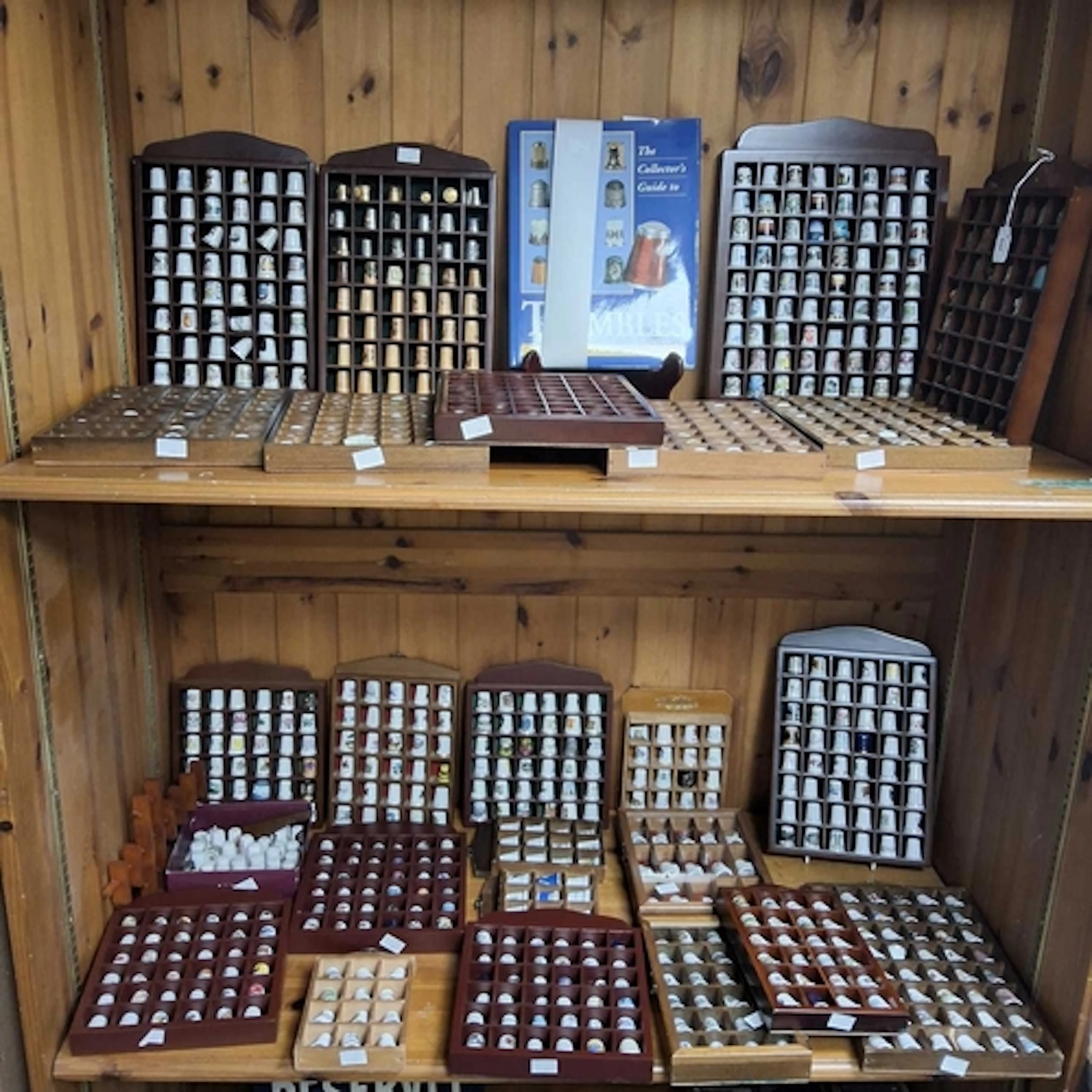 A LARGE COLLECTION OF THIMBLES, A BOOK, AND DISPLAY CASES, a...