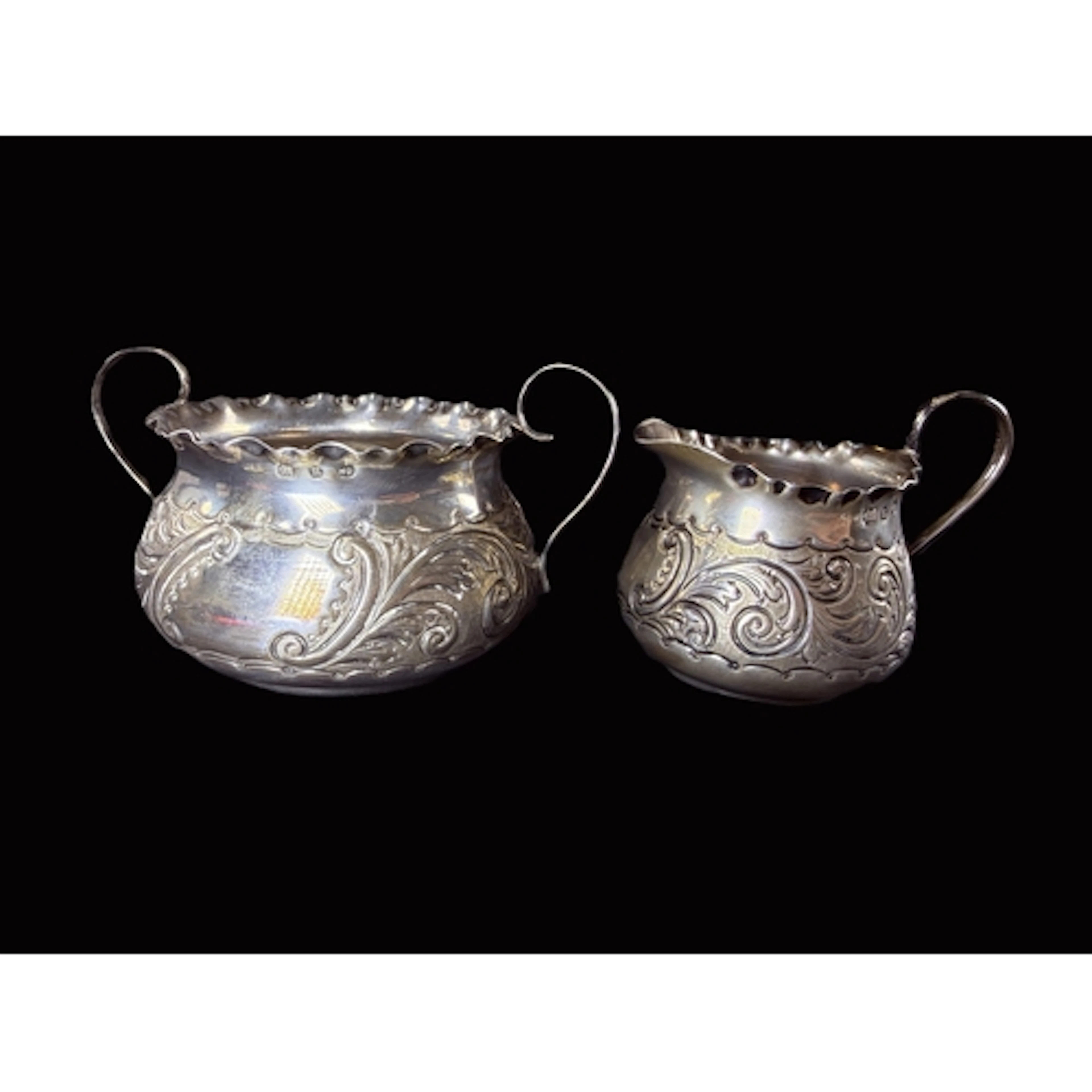 A silver sugar and cream set, late Victorian rococo style, B...