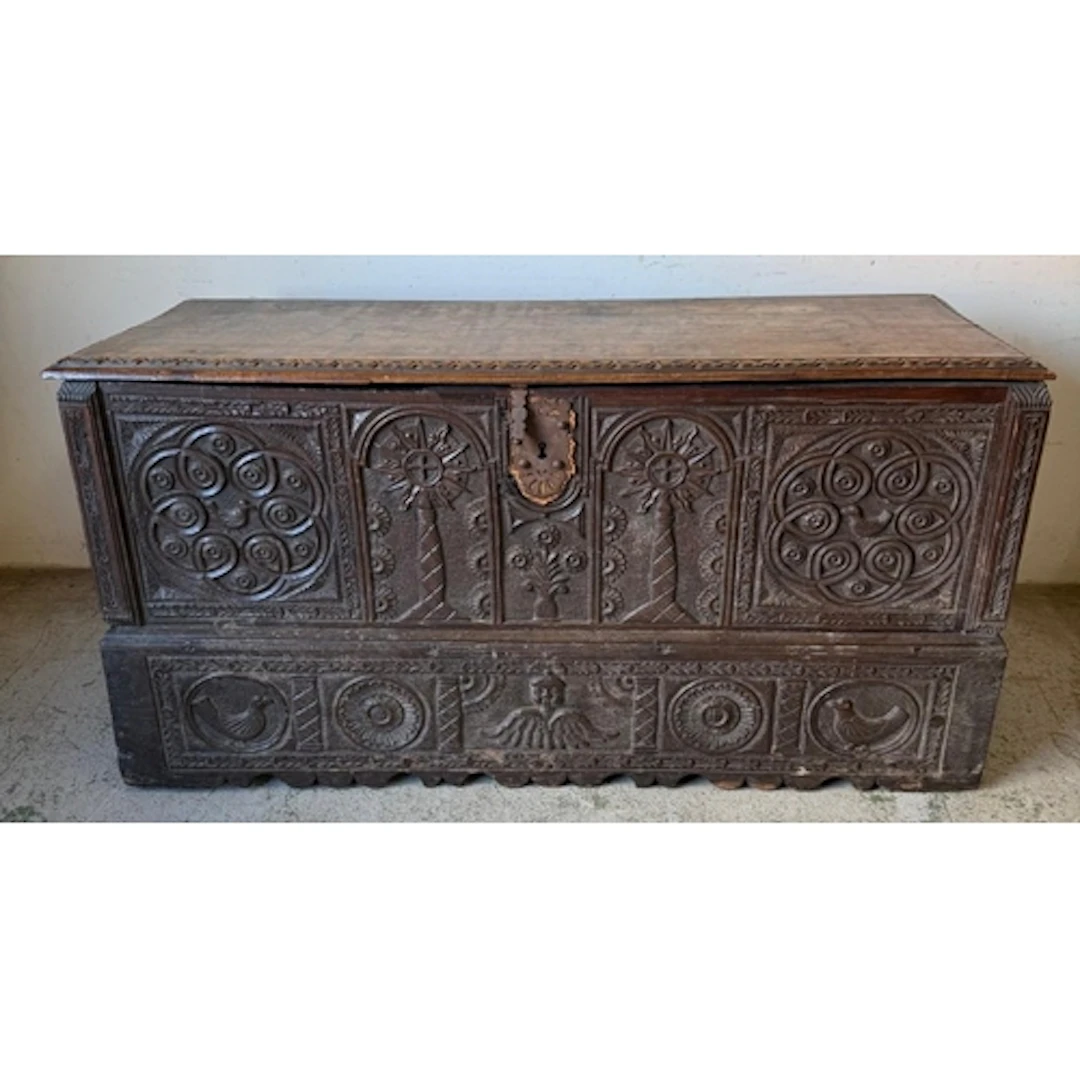 A continental Oak coffer, front carved panels decorated with...
