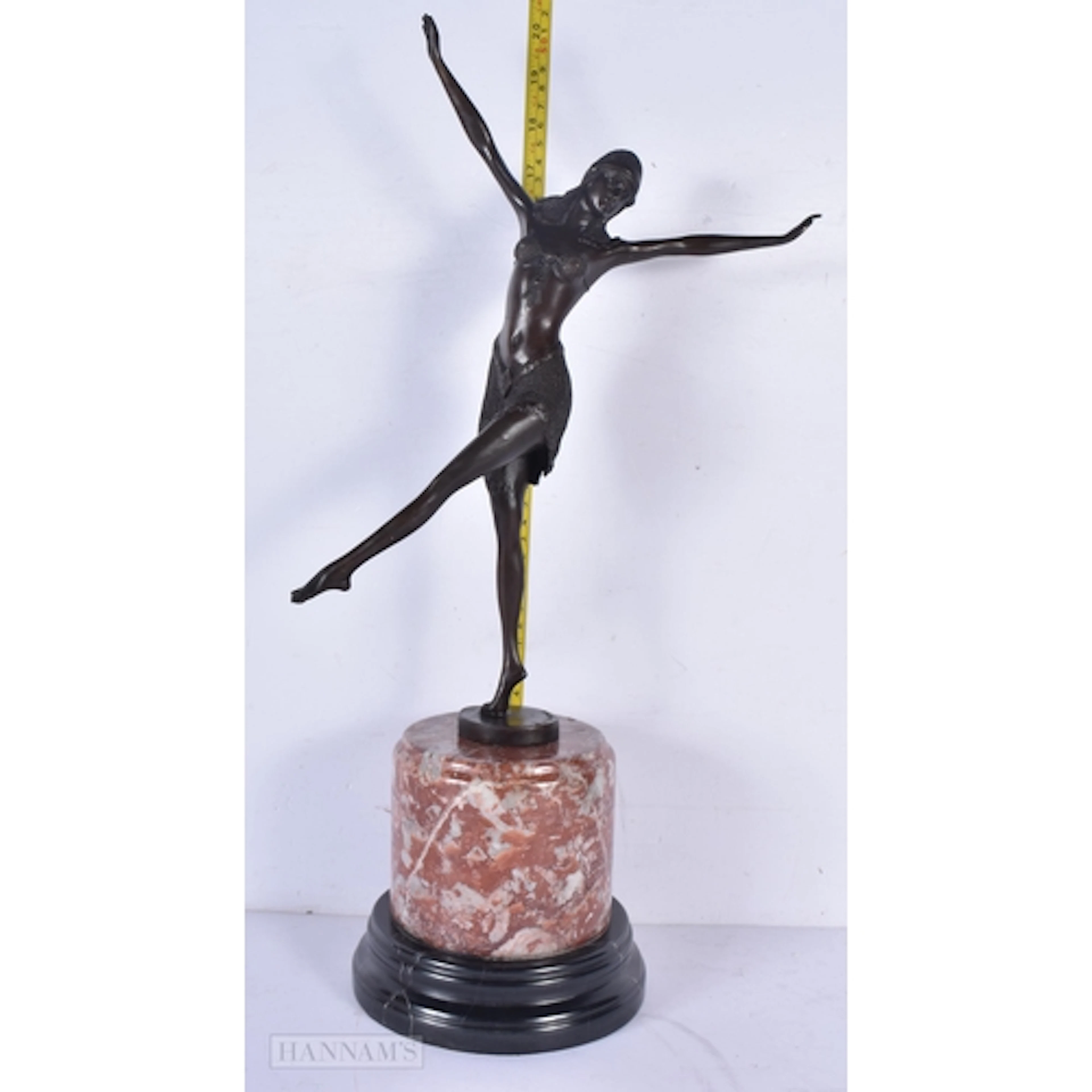 A marble mounted art deco style bronzed dancing figure of a ...