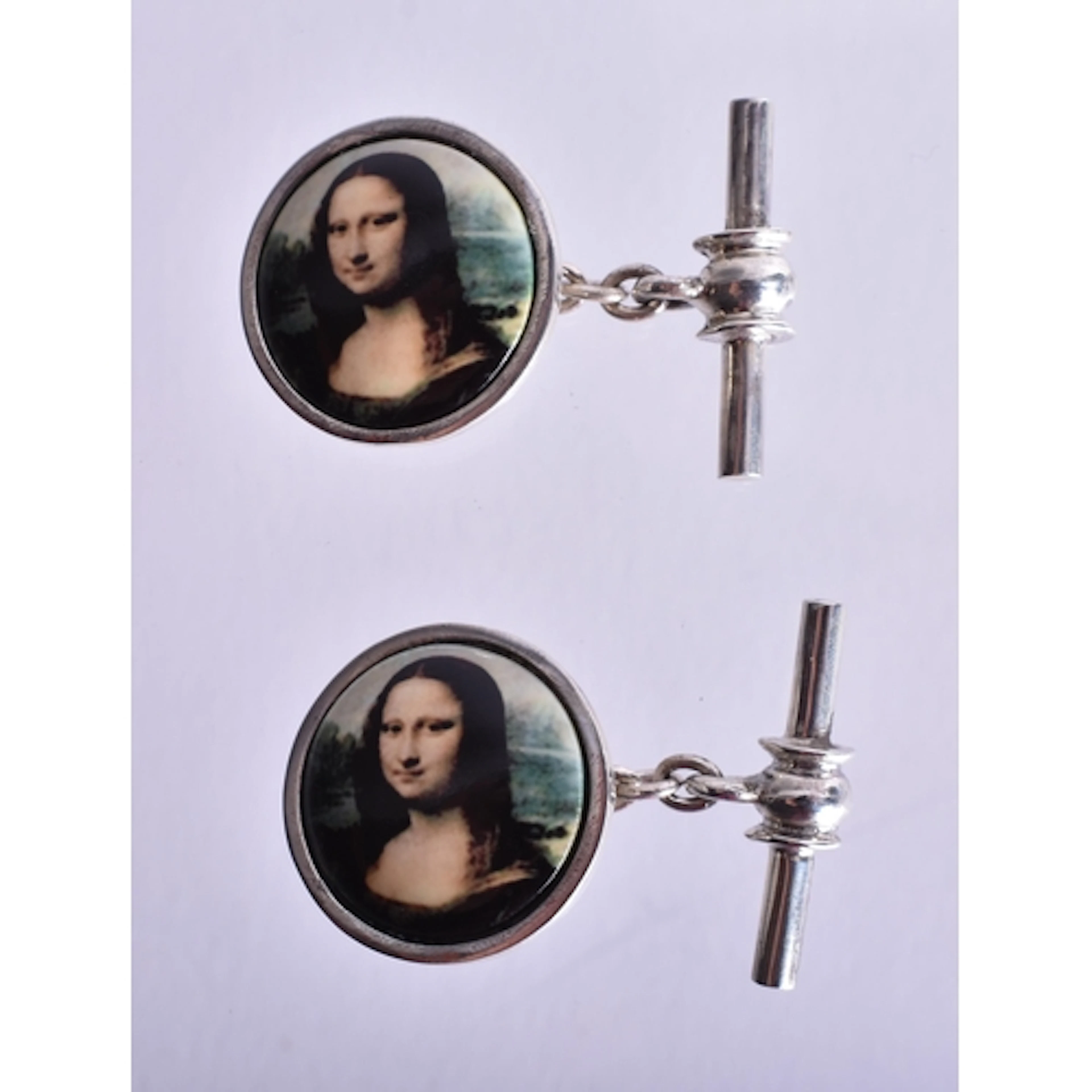 A Pair of Silver Mounted Mona Lisa Cufflinks. Stamped 925. 1...