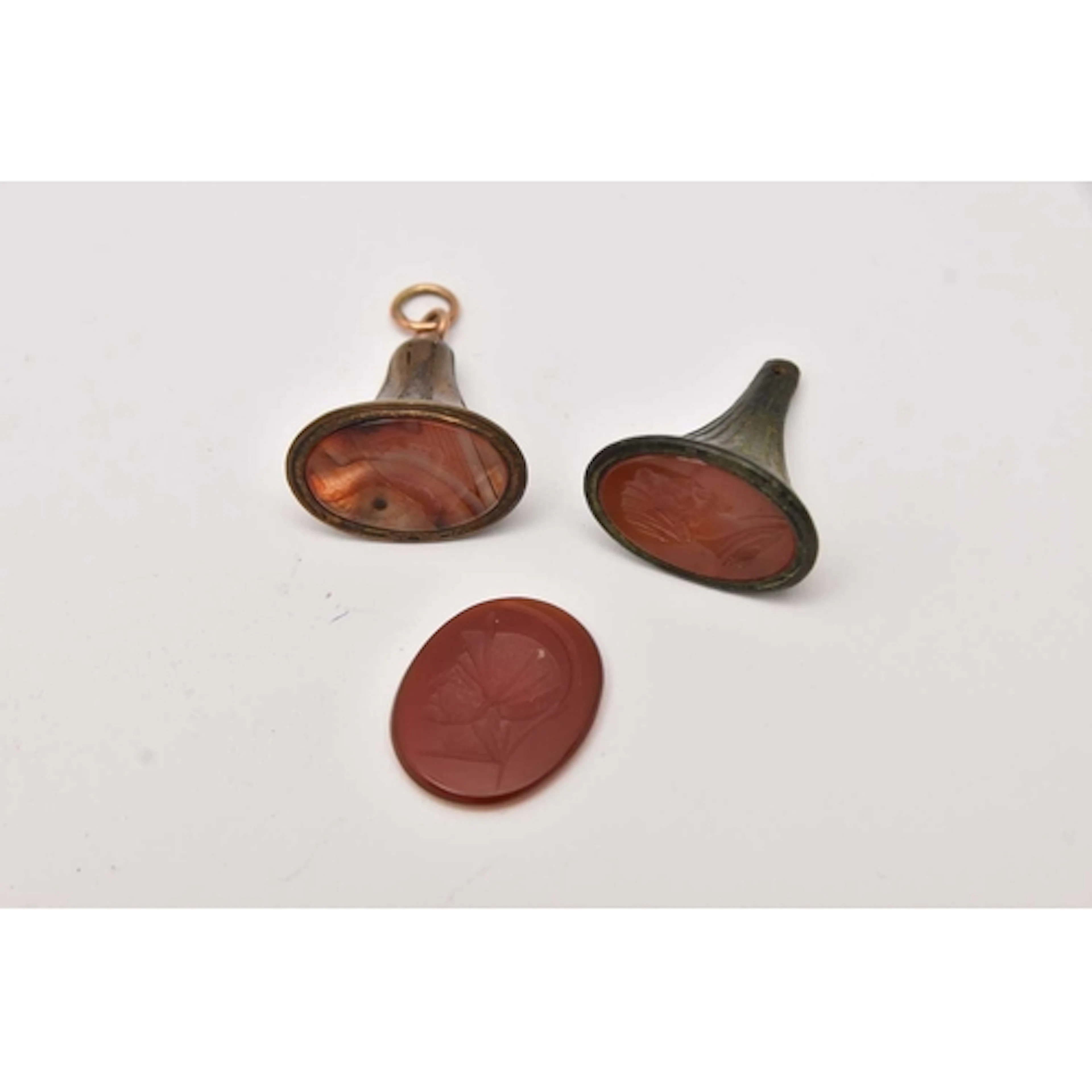 TWO FOB SEALS AND A LOOSE CARNELIAN INTAGLIO INLAY, all engr...