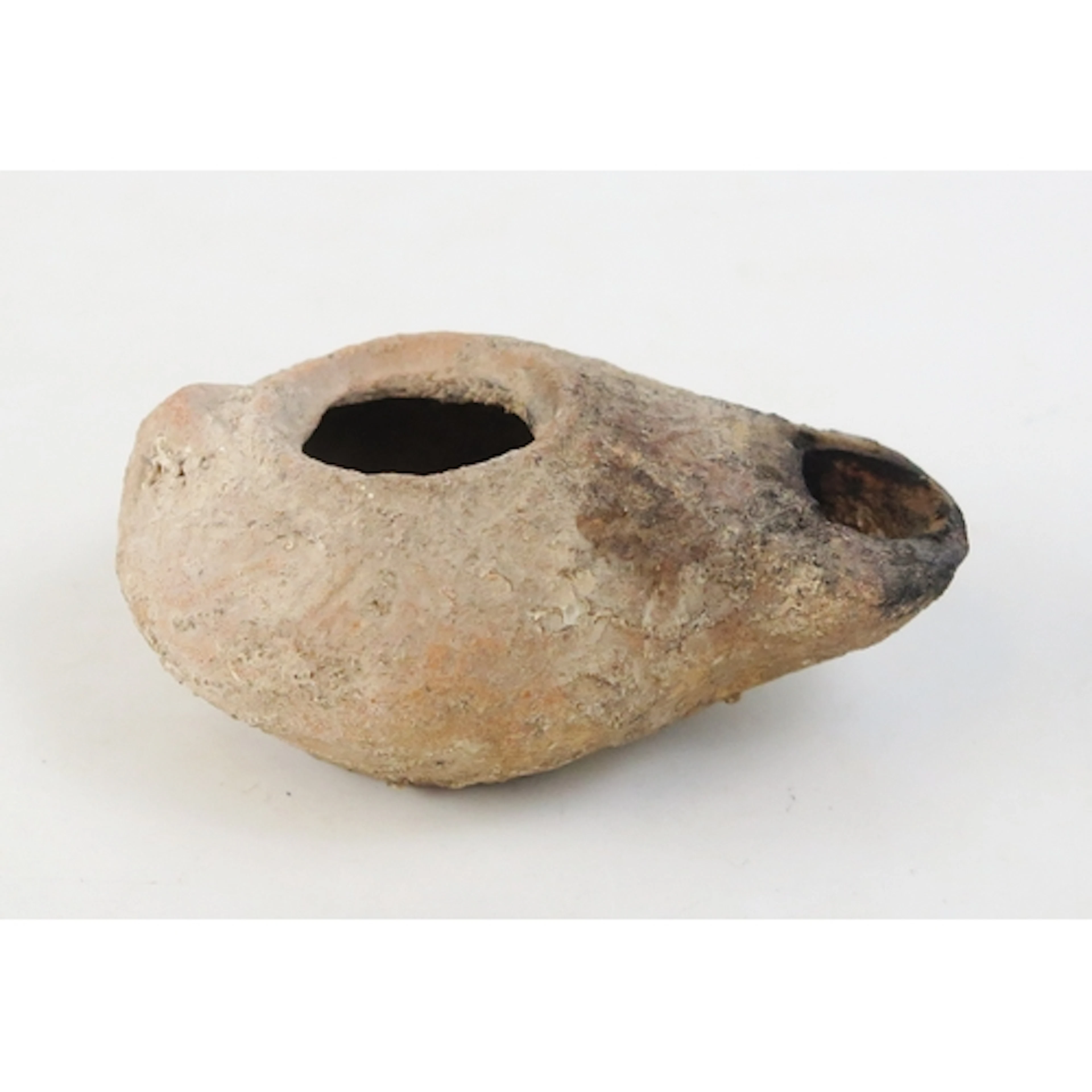 A Roman pottery oil lamp of traditional design with raised d...