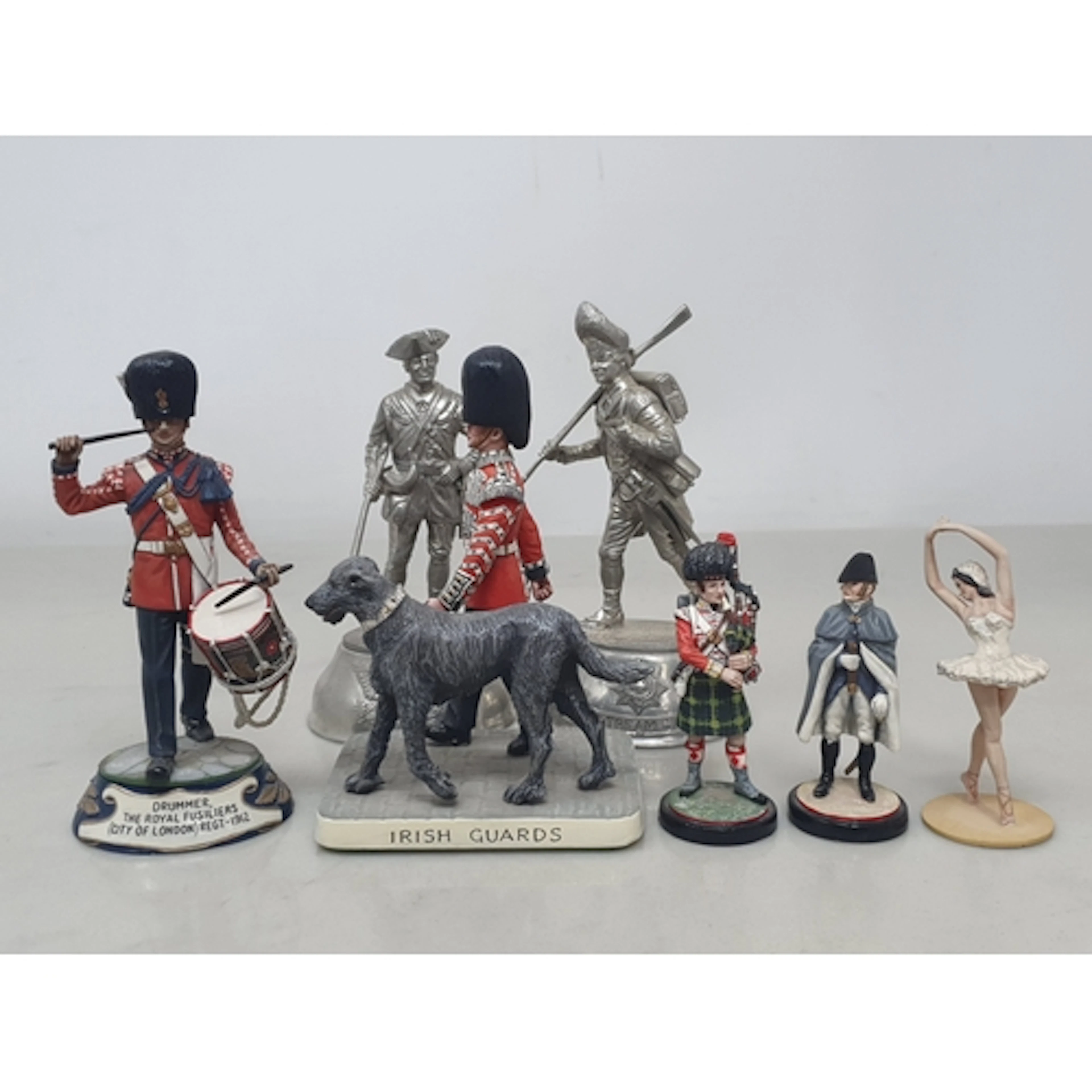A collection of Charles Stadden and other painted white meta...