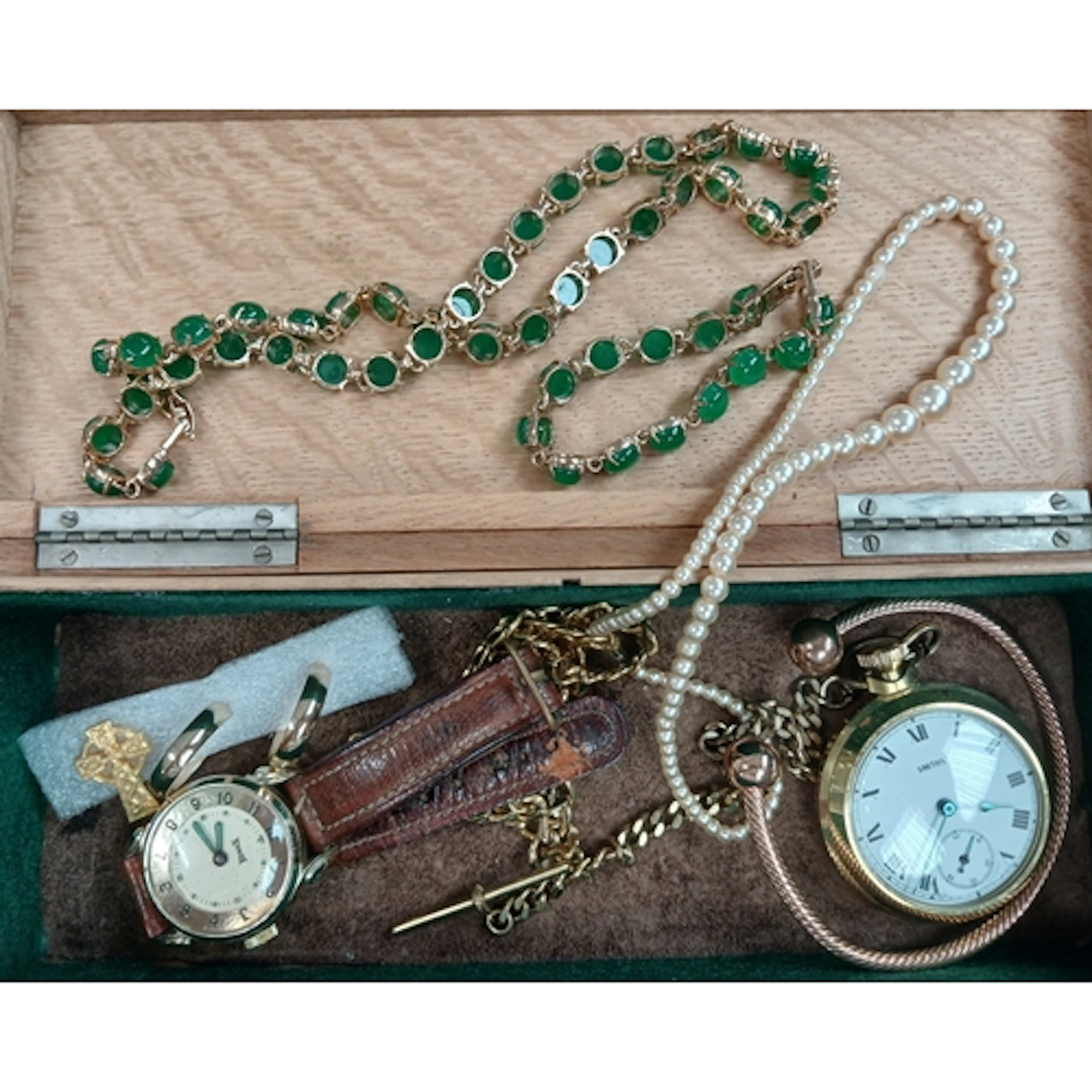A wooden box of mainly gold plated costume jewellery and wat...