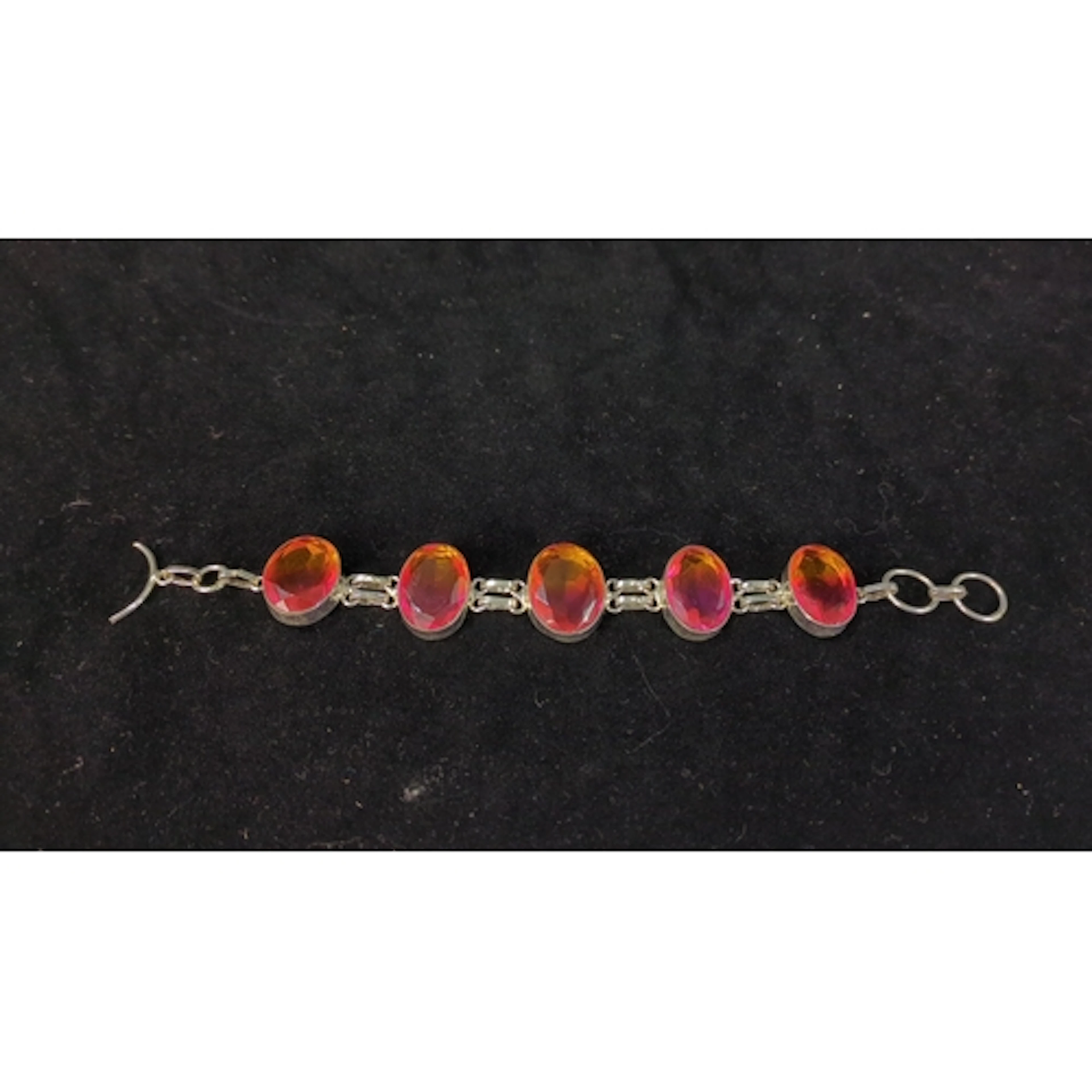 Sterling silver bracelet set with five faceted oval stones d...