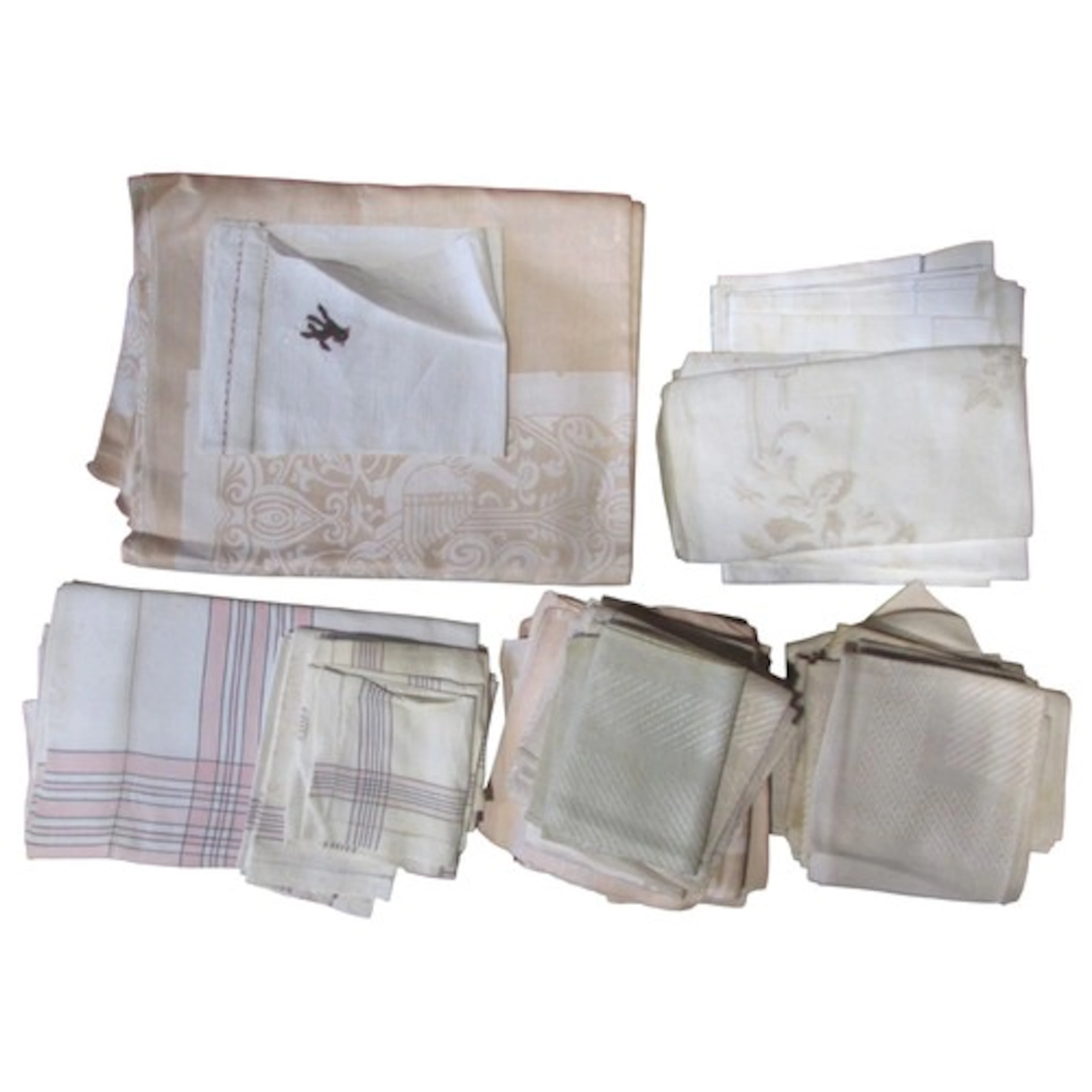 A collection of table linen, mostly napkins in a pale pink a...
