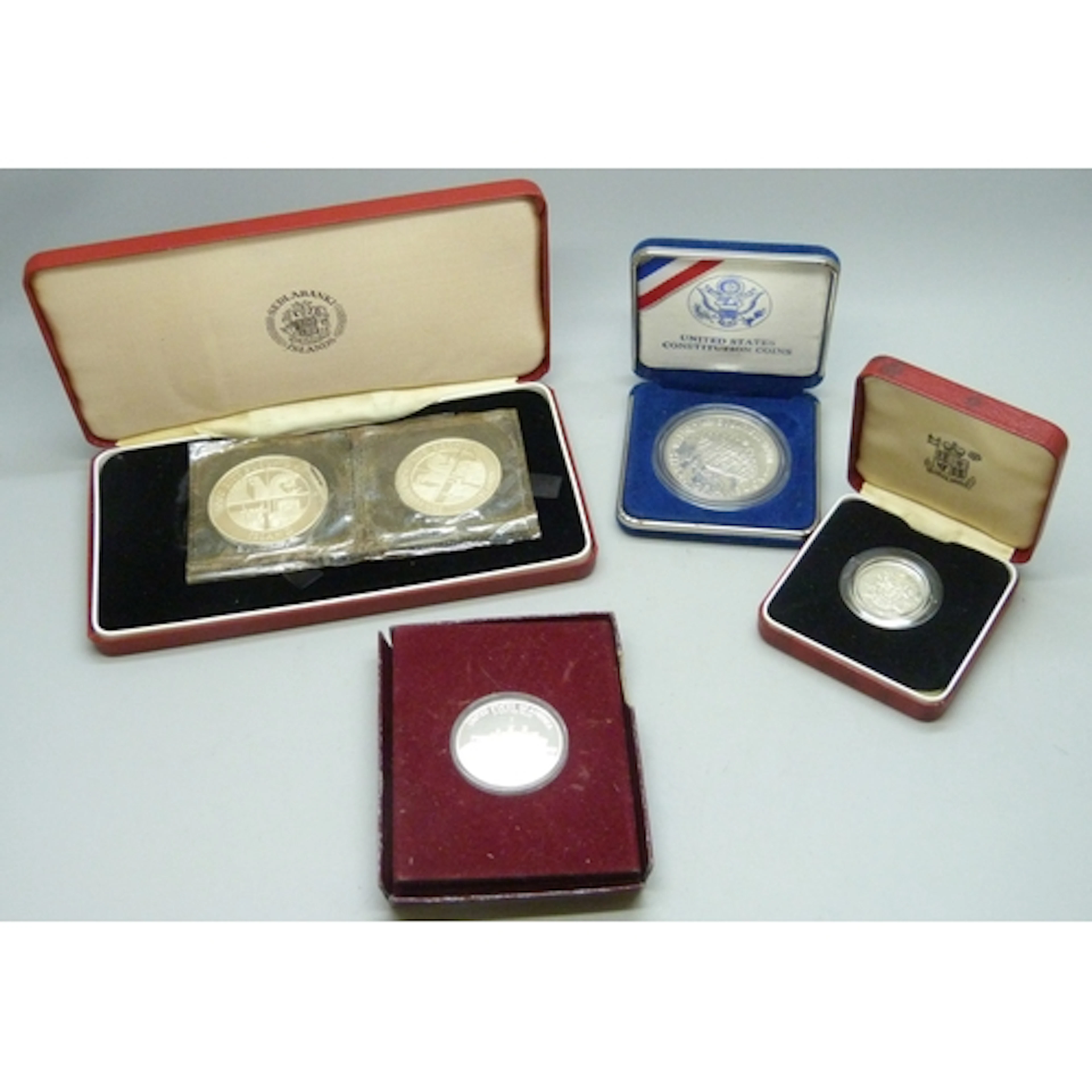 Coins - a USA commemorative half-dollar, a USA 1 dollar coin...