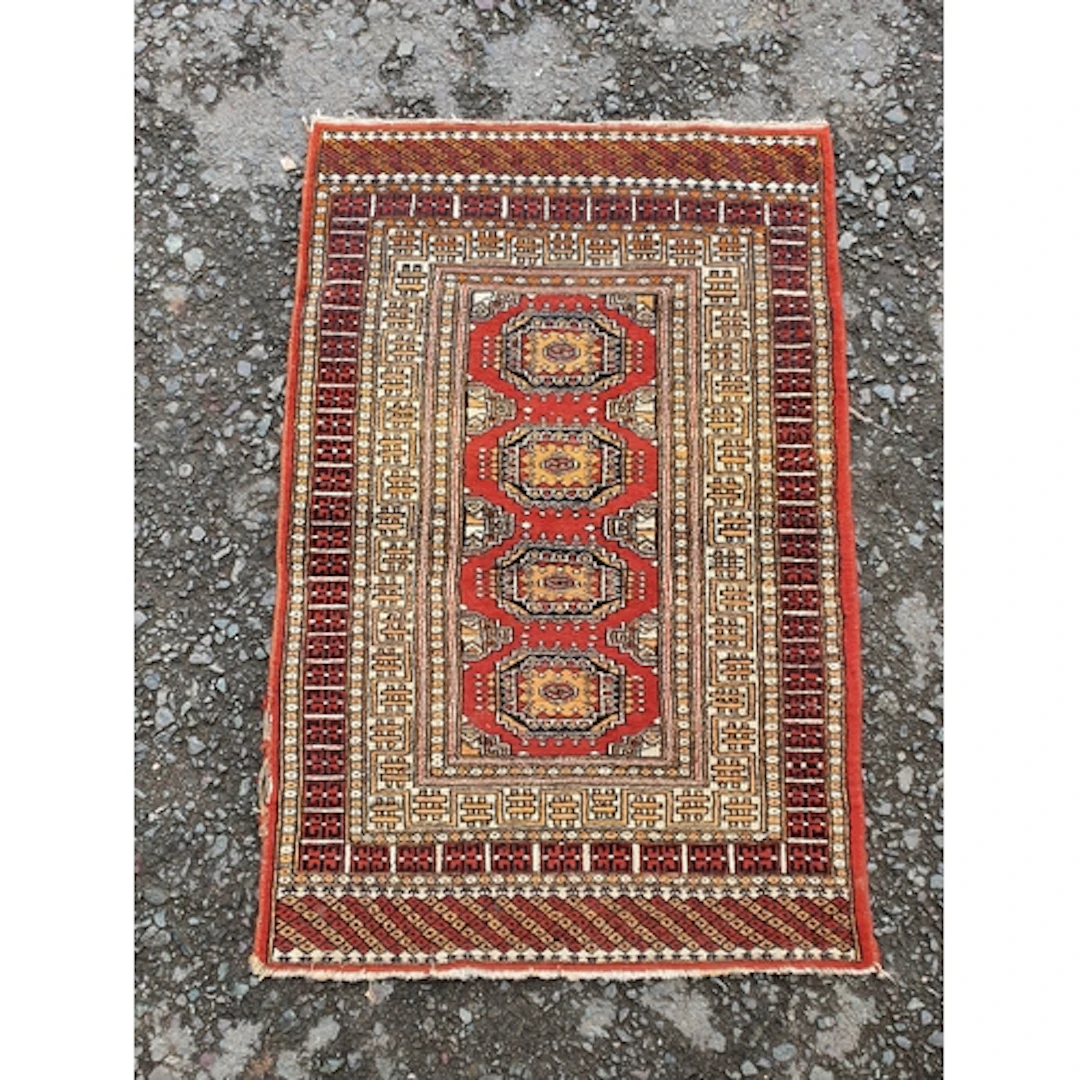 A modern multi bordered Rug on a red ground.