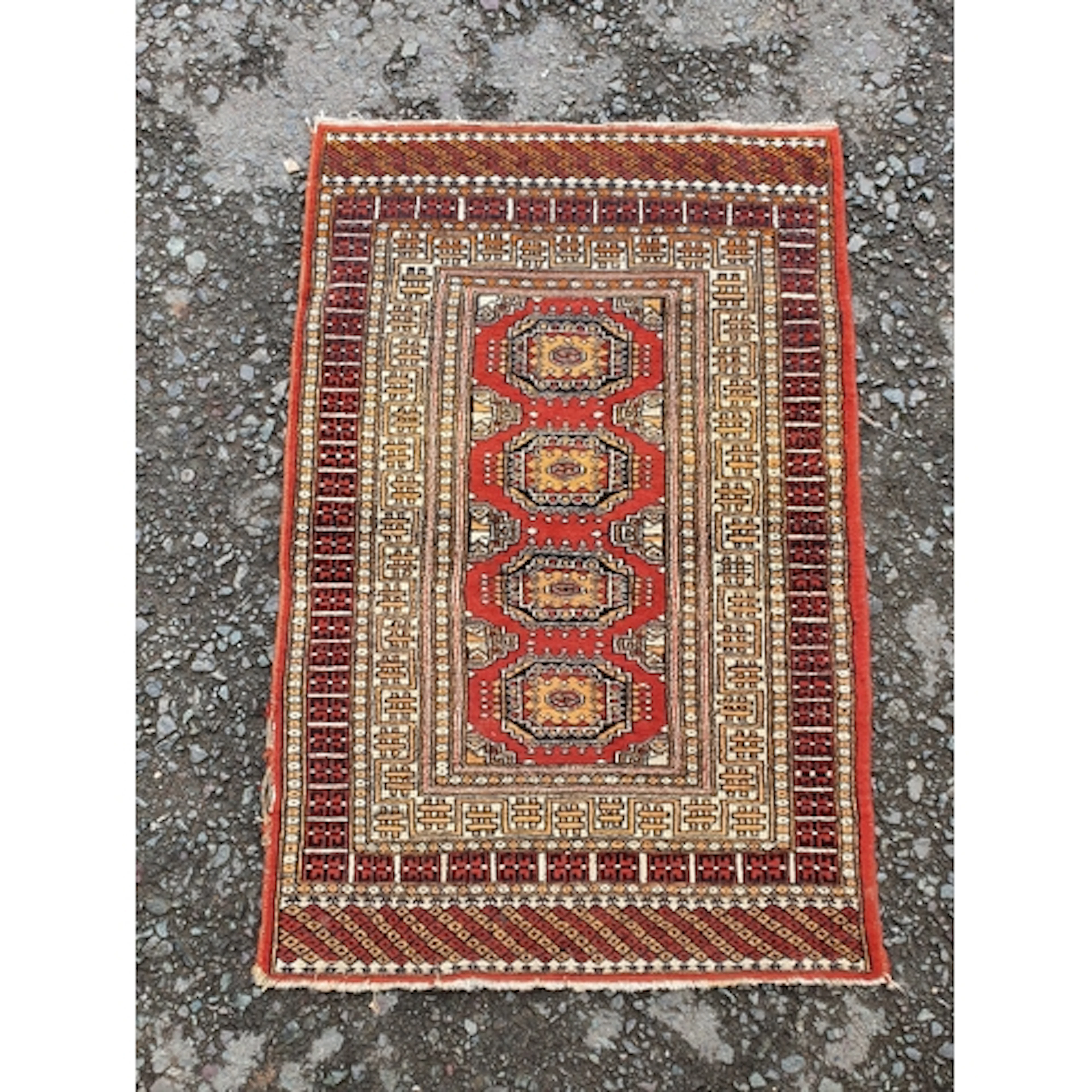 A modern multi bordered Rug on a red ground.