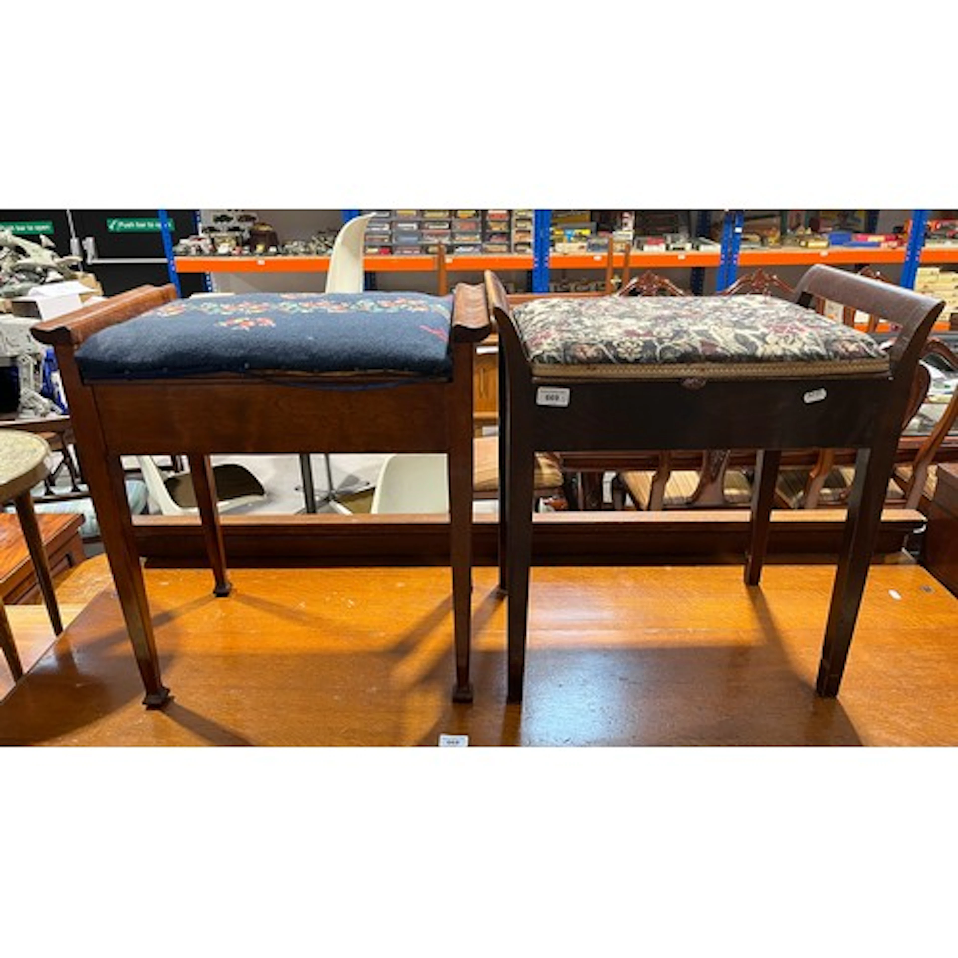 Two mahogany piano stools, each with hinged cushion seat. (...