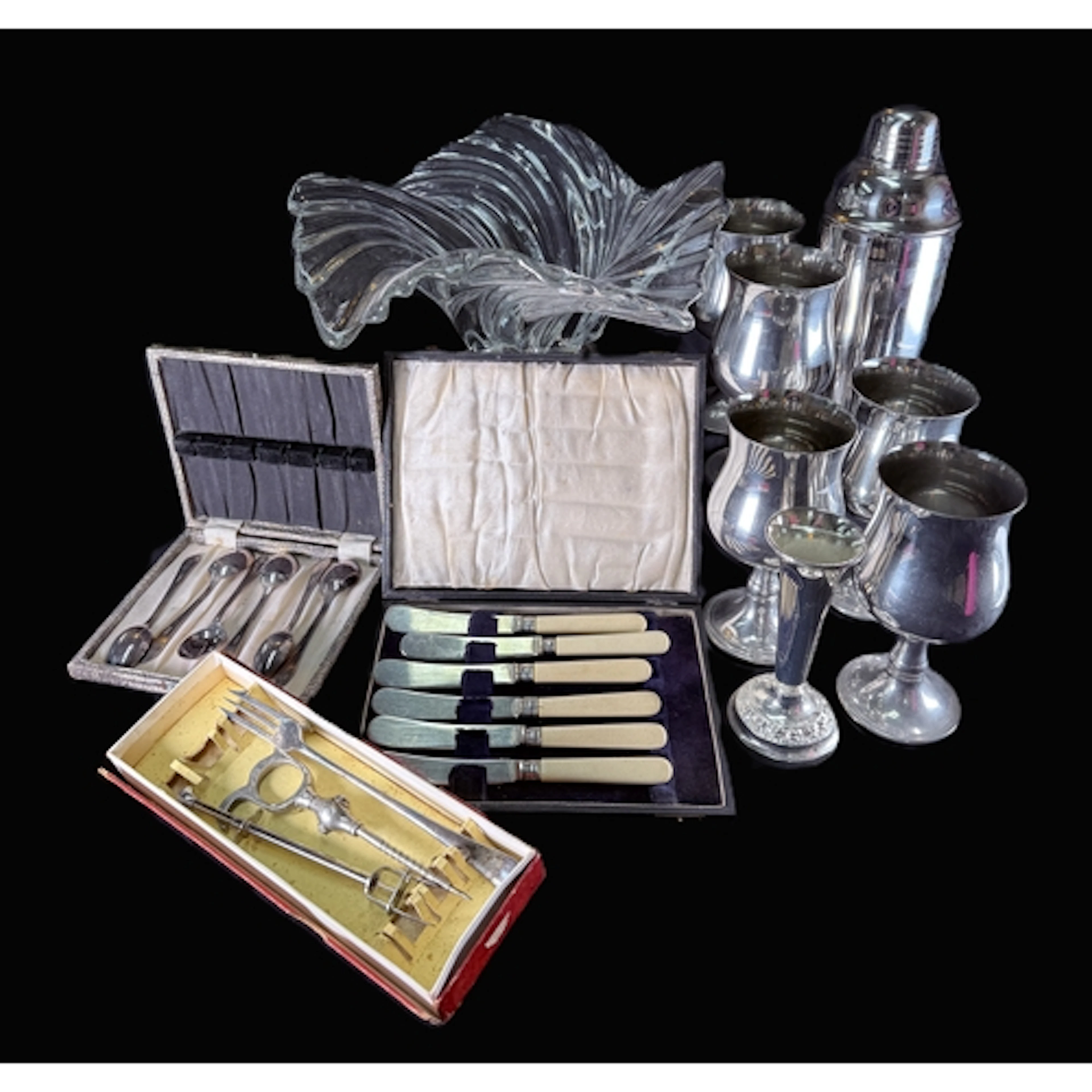 A silver based abstract glass dish, a selection of cutlery a...