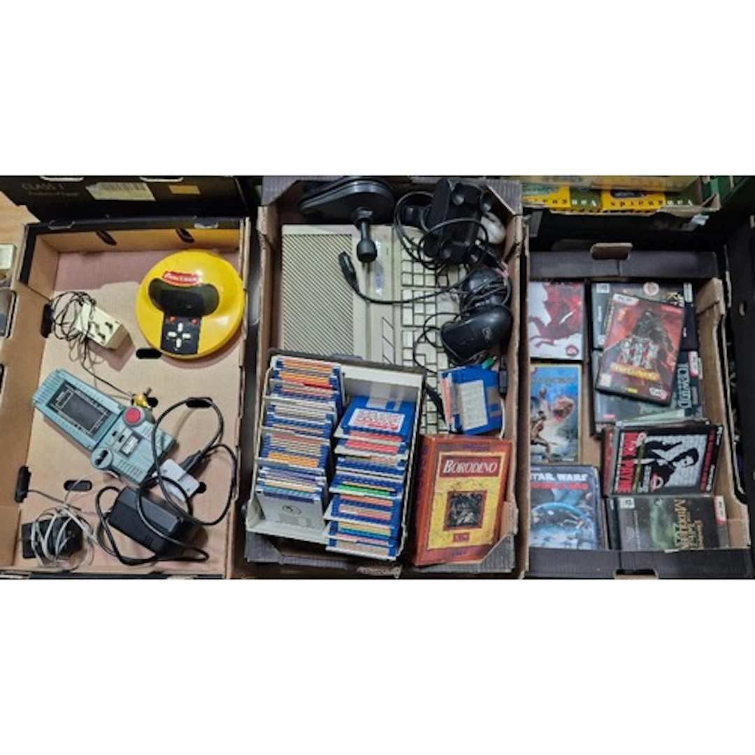 Three boxes of assorted electronics to include an atari 520S...