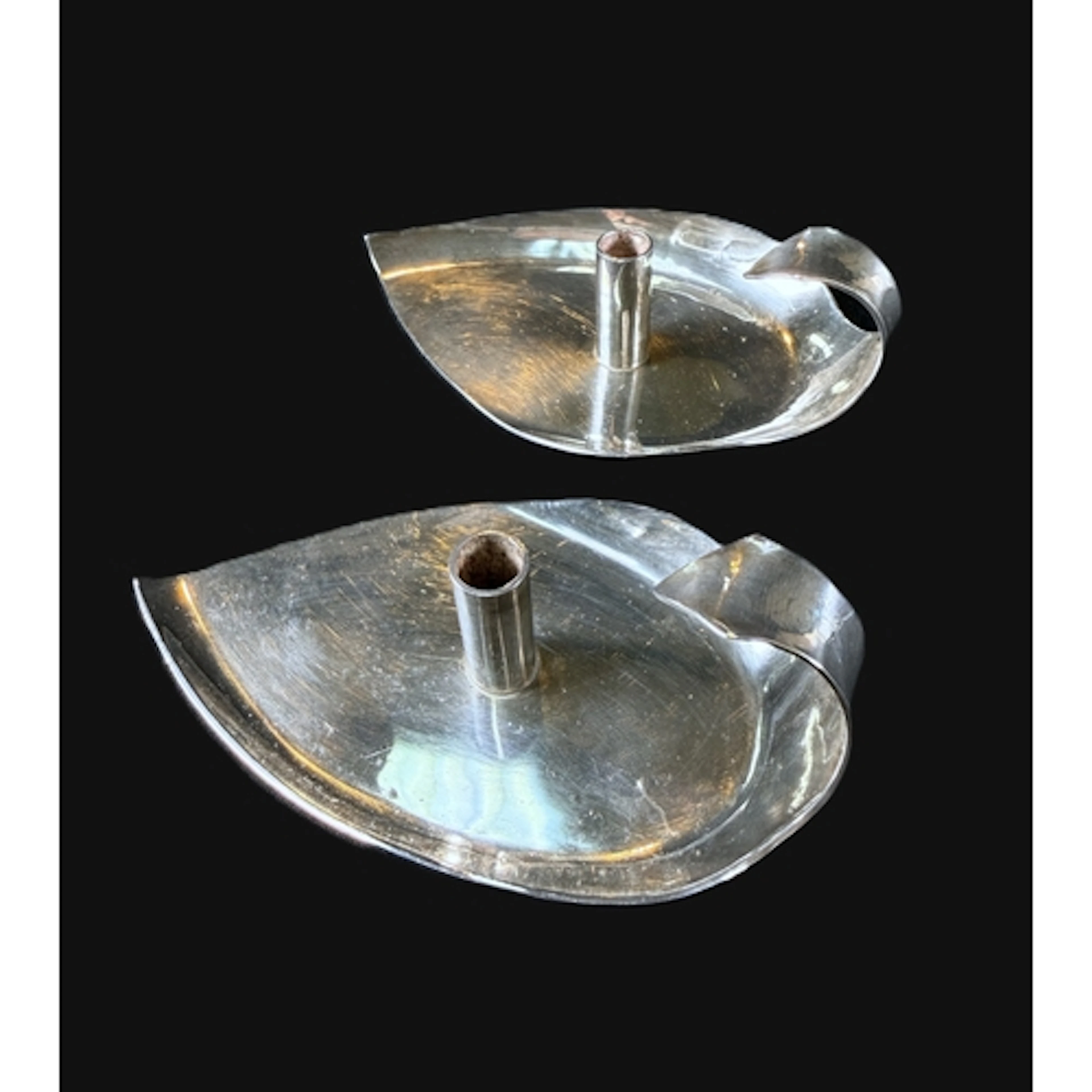 Two hall marked silver modernist candle holders in the form ...