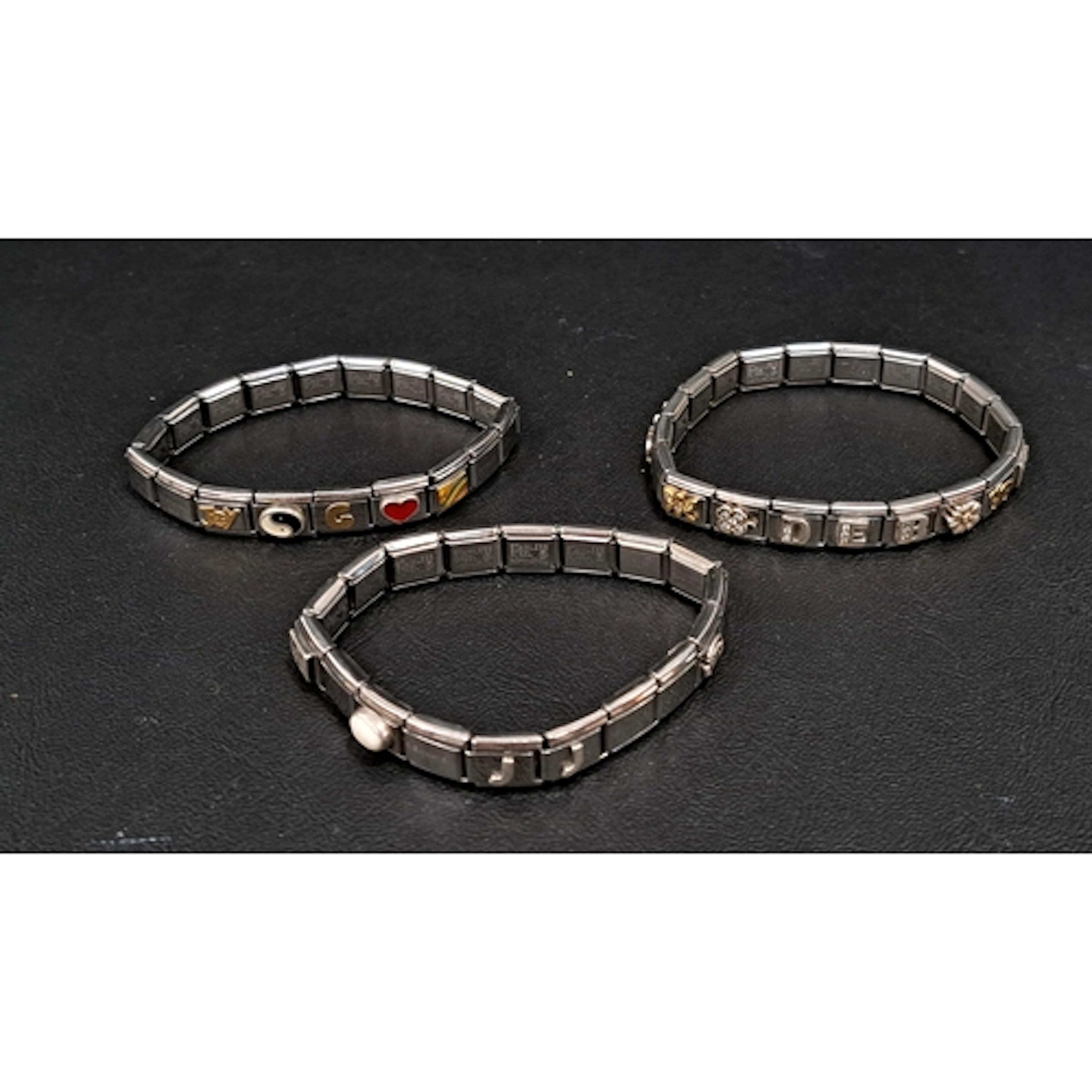 THREE NOMINATION CHARM BRACELETS with a total of 31 charms